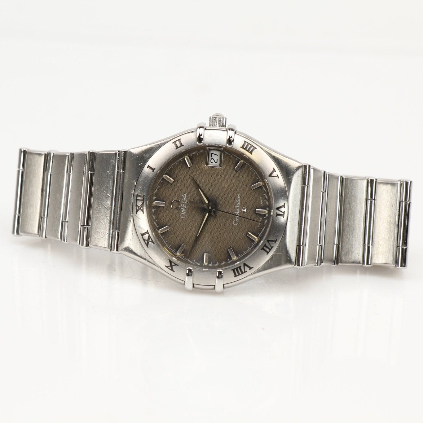 Omega Constellation Chronometer watch with gold-tone case and bracelet, showcasing a sleek, elegant design and detailed dial.