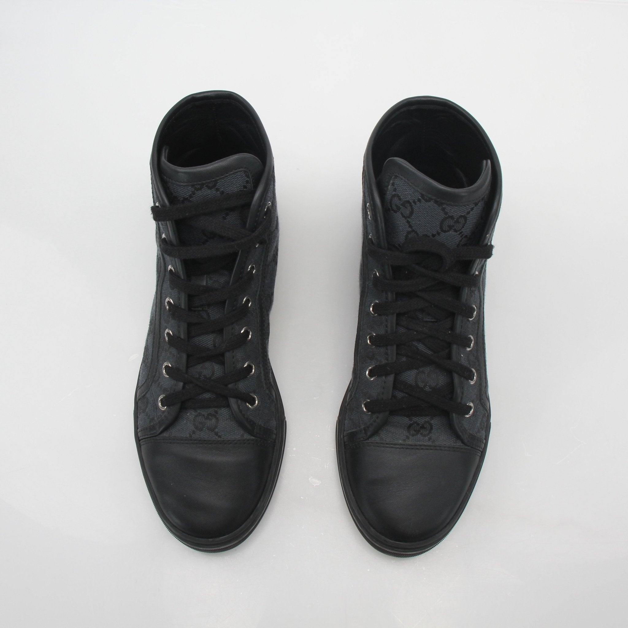 Gucci black GG canvas high-top sneakers with white rubber soles and laces, stylish and comfortable shoes for casual wear.