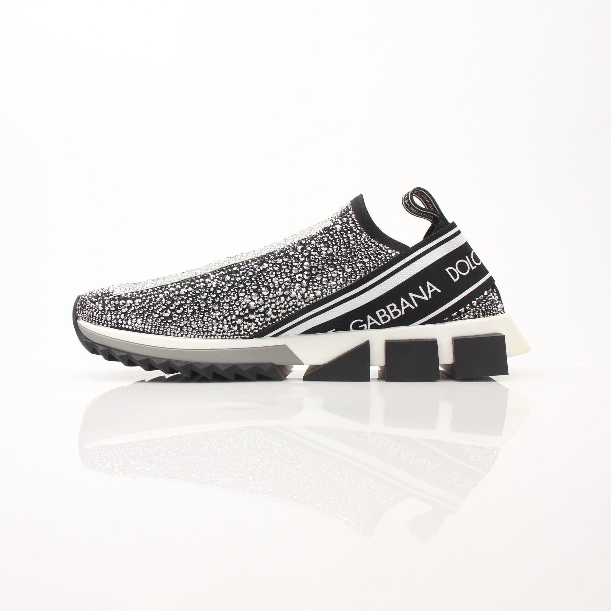 Gold & Beyond Dolce & Gabbana Sorrento Crystal Logo slip-on sneakers with clear crystal accents and white soles.