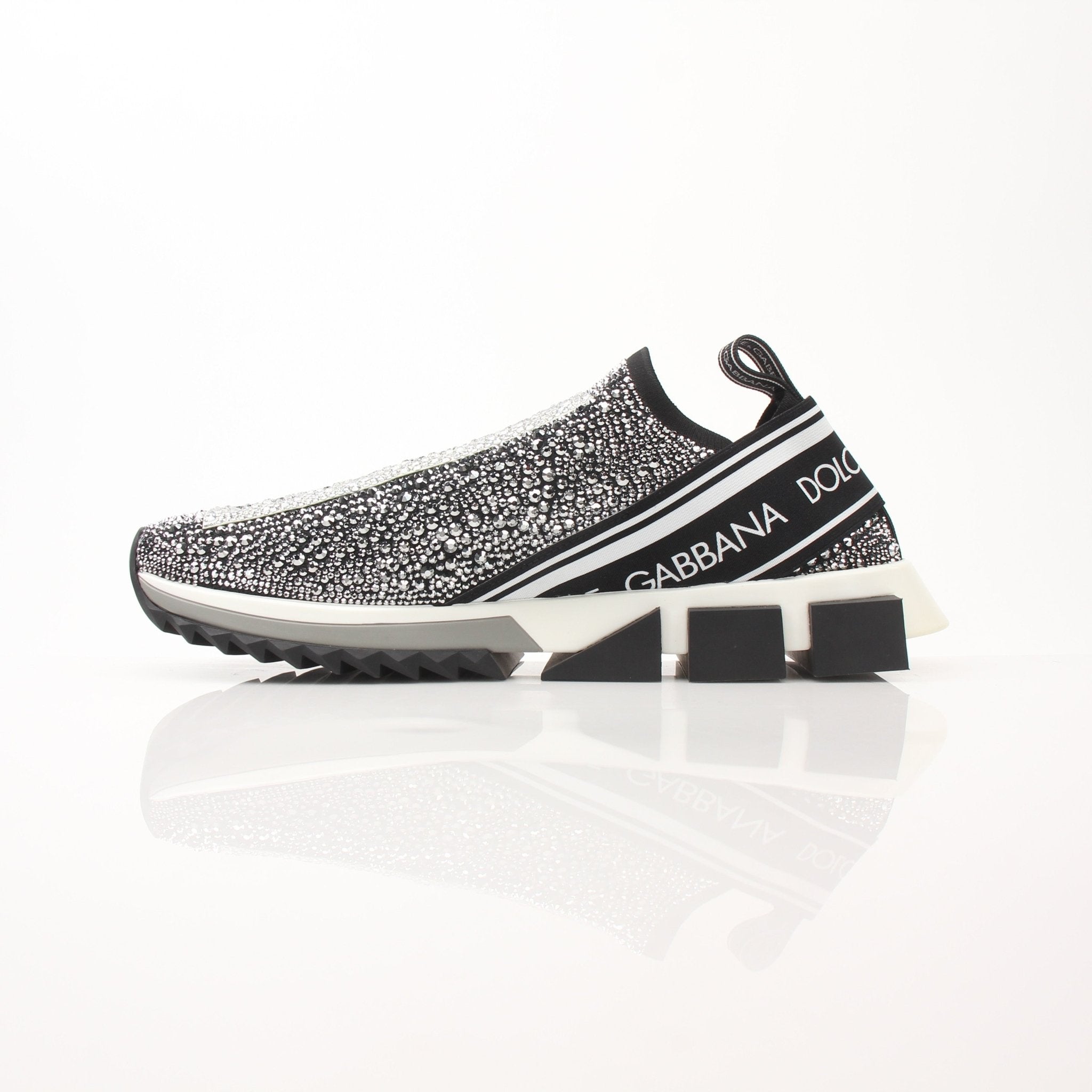 Gold & Beyond Dolce & Gabbana Sorrento Crystal Logo slip-on sneakers with clear crystal accents and white soles.