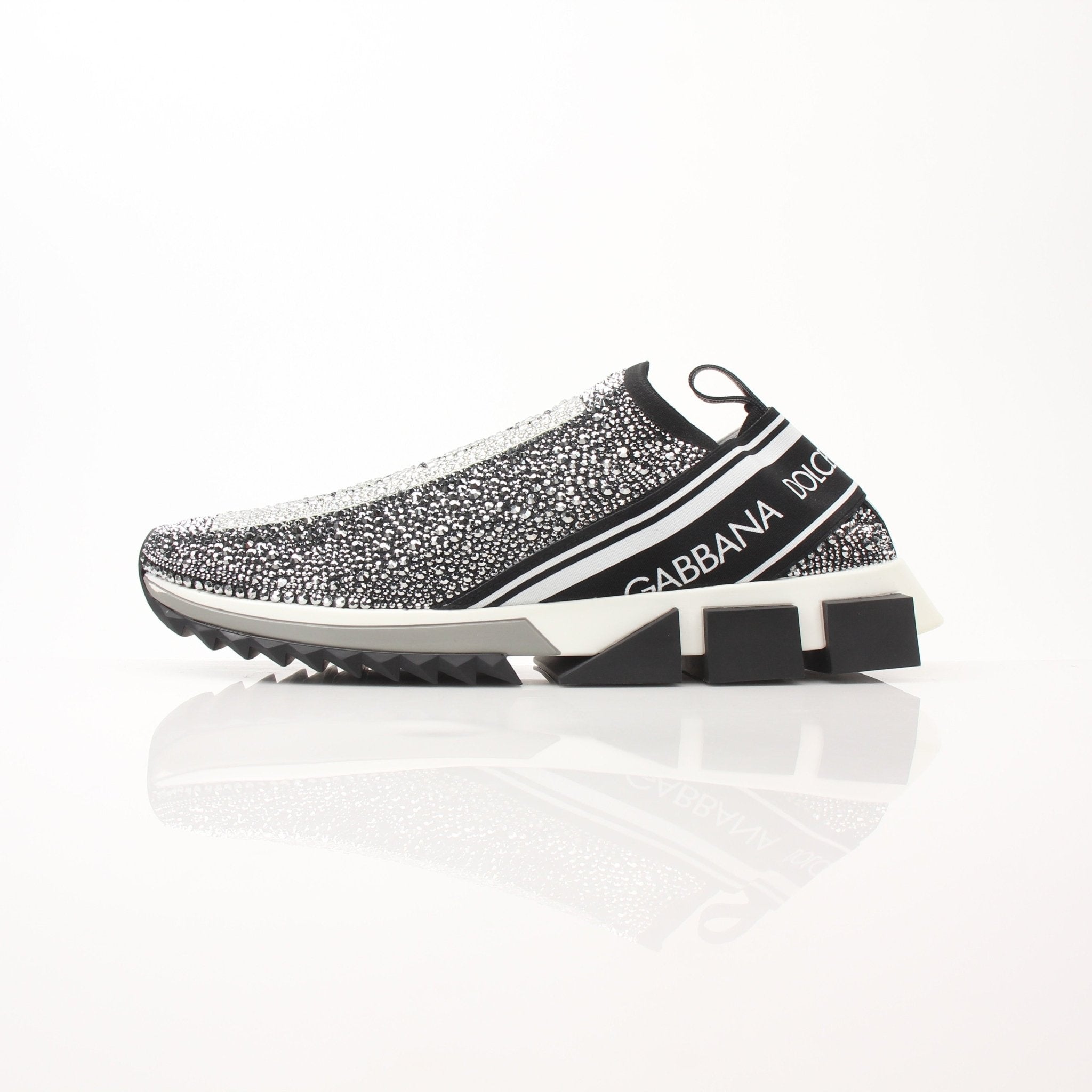 Gold & Beyond Dolce & Gabbana Sorrento Crystal Logo slip-on sneakers with clear crystal accents and sleek shoe design.