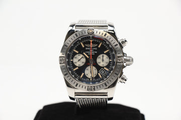 Breitling Super Avenger Chronograph AB0115 watch with stainless steel mesh bracelet on a neutral background.