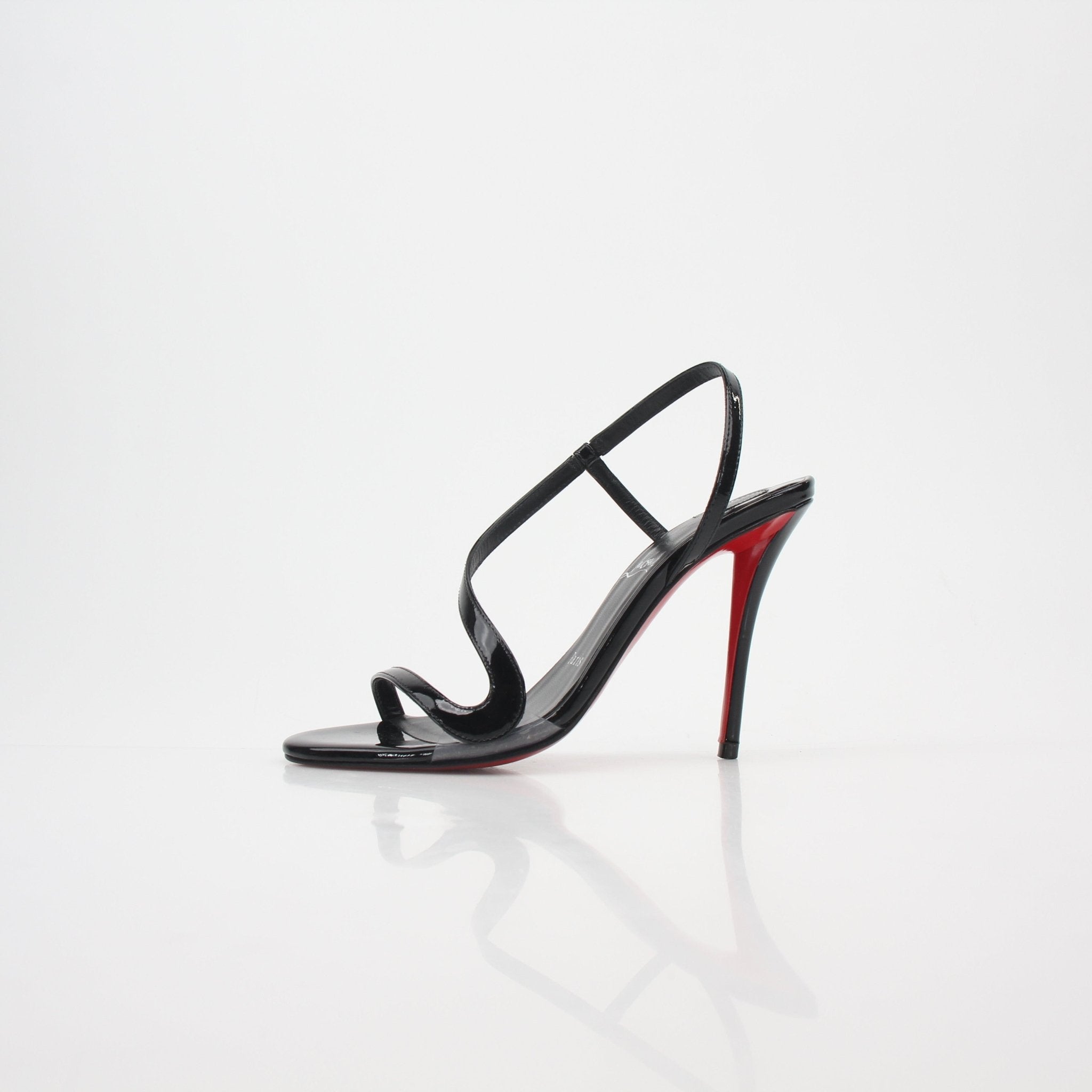 Black Christian Louboutin Rosa Z 100 patent leather heels with ankle straps and signature red soles.