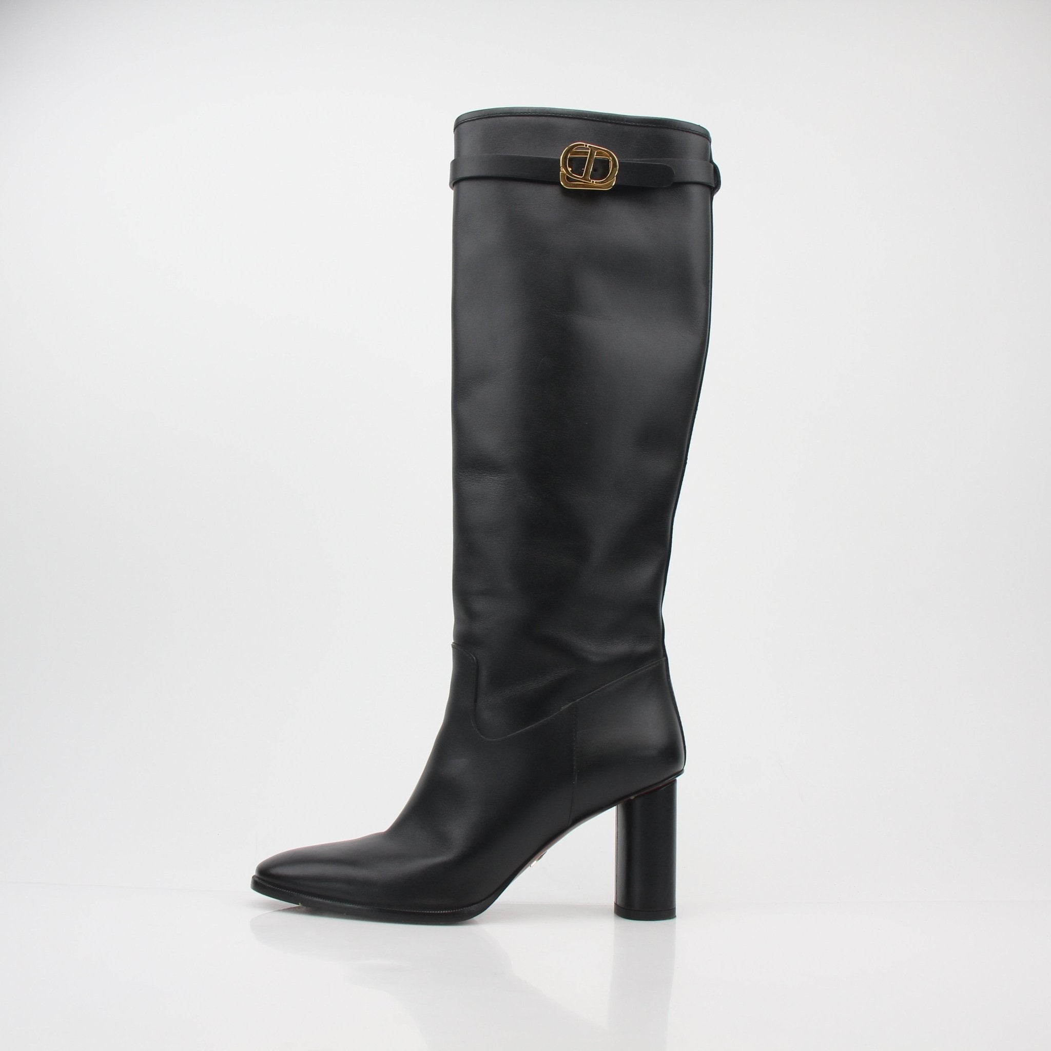 Christian Dior black leather Empreinte heeled boots, stylish shoes with block heels and embossed Dior logo, displayed on a neutral background.