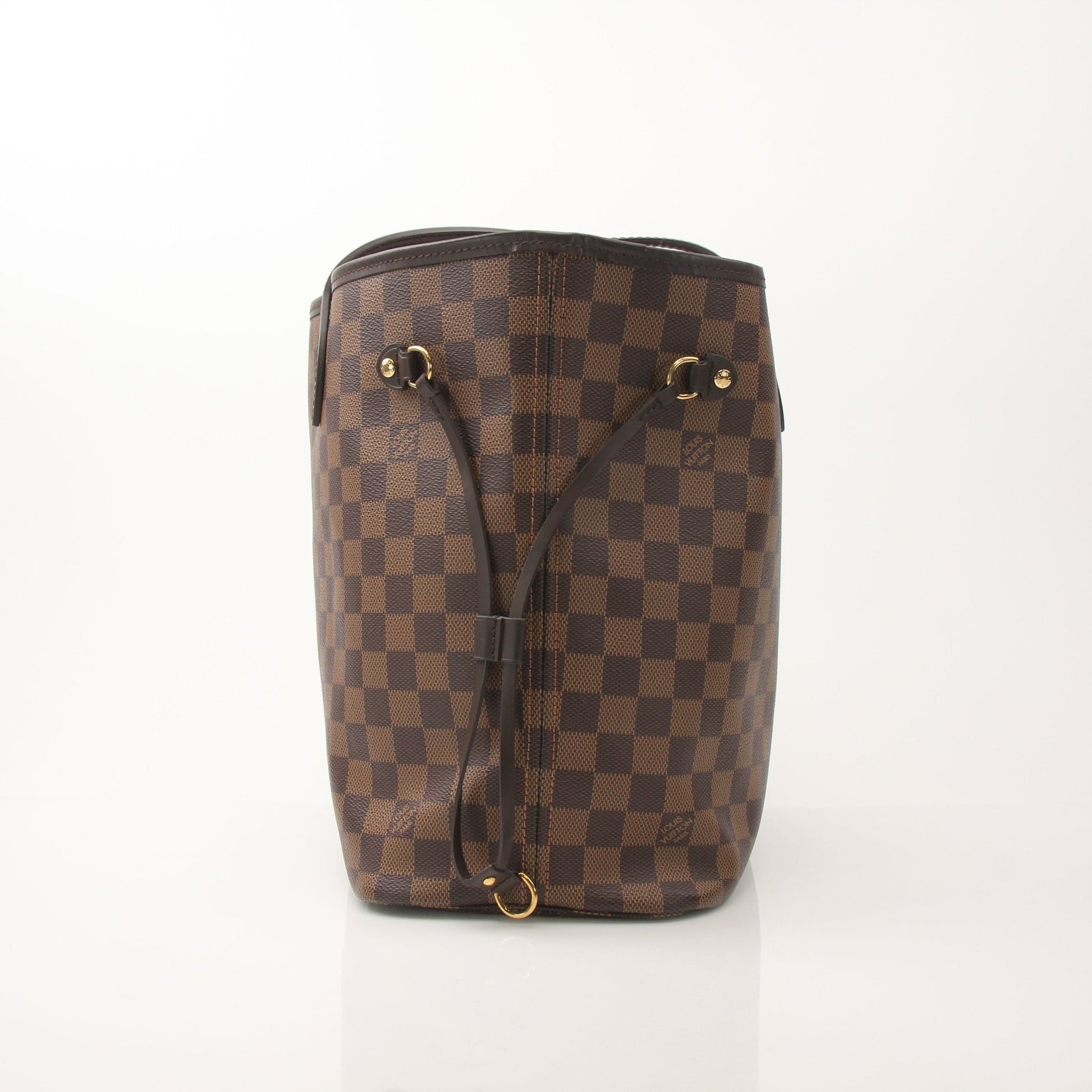Louis Vuitton Neverfull MM tote bag hand-held by a person, showcasing the iconic monogram canvas and leather trim.