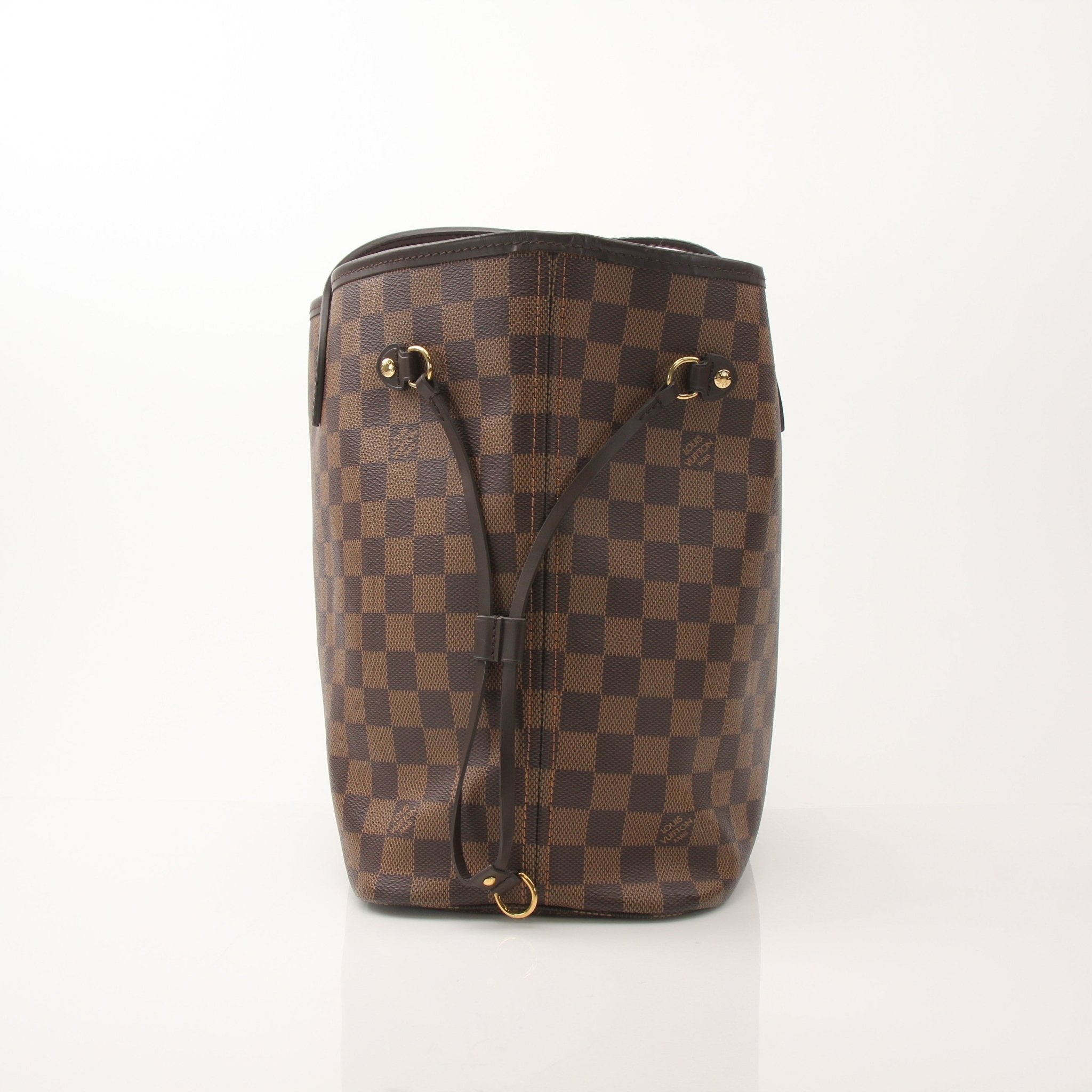 Louis Vuitton Neverfull MM tote bag hand-held by a person, showcasing the iconic monogram canvas and leather trim.