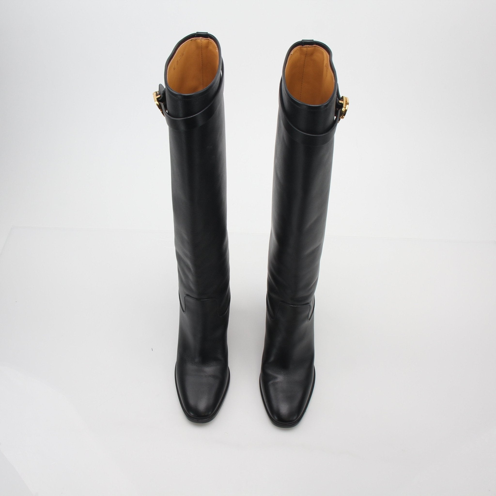 Christian Dior black leather Empreinte heeled boots with pointed toes and sleek design, displayed on a neutral background.