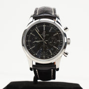 Gold & Beyond Breitling automatic chronograph watch with black dial, stainless steel case, and leather strap on a display stand.