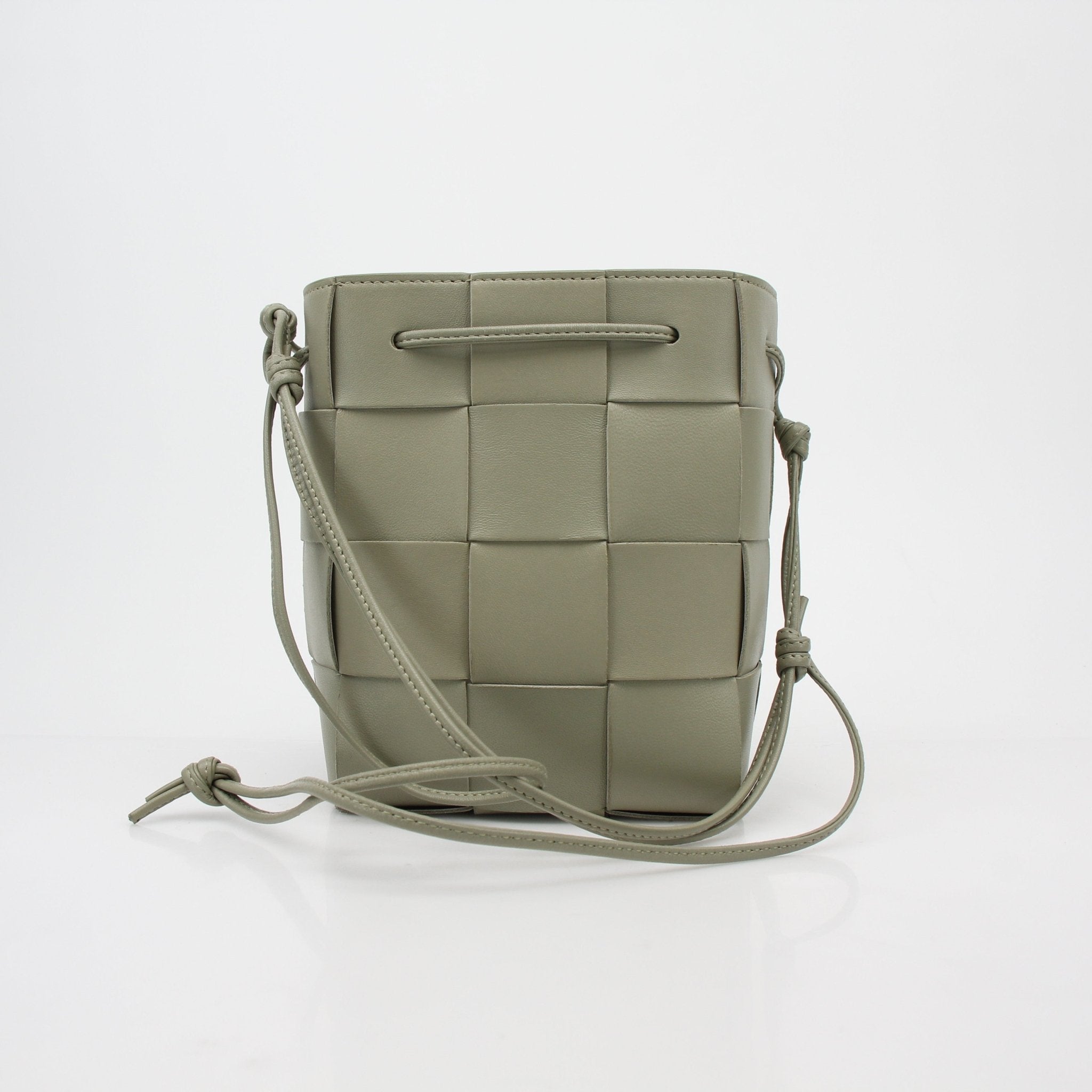 Gold & Beyond Bottega Veneta Chalk Cassette Bucket Bag handbag with woven leather design and gold-tone hardware.