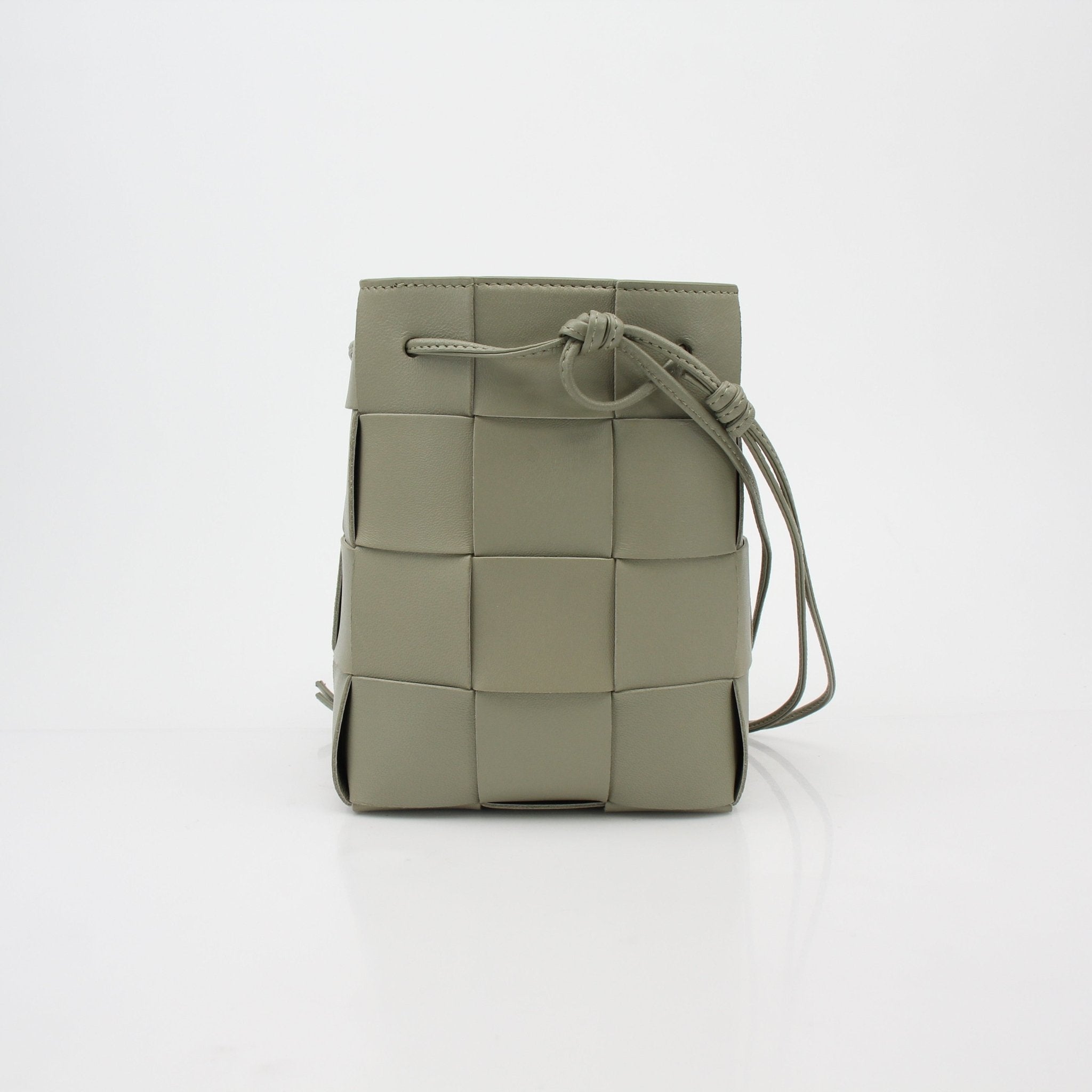 Gold & Beyond Bottega Veneta Chalk Cassette Bucket Bag, stylish handbag with woven leather design and spacious interior.