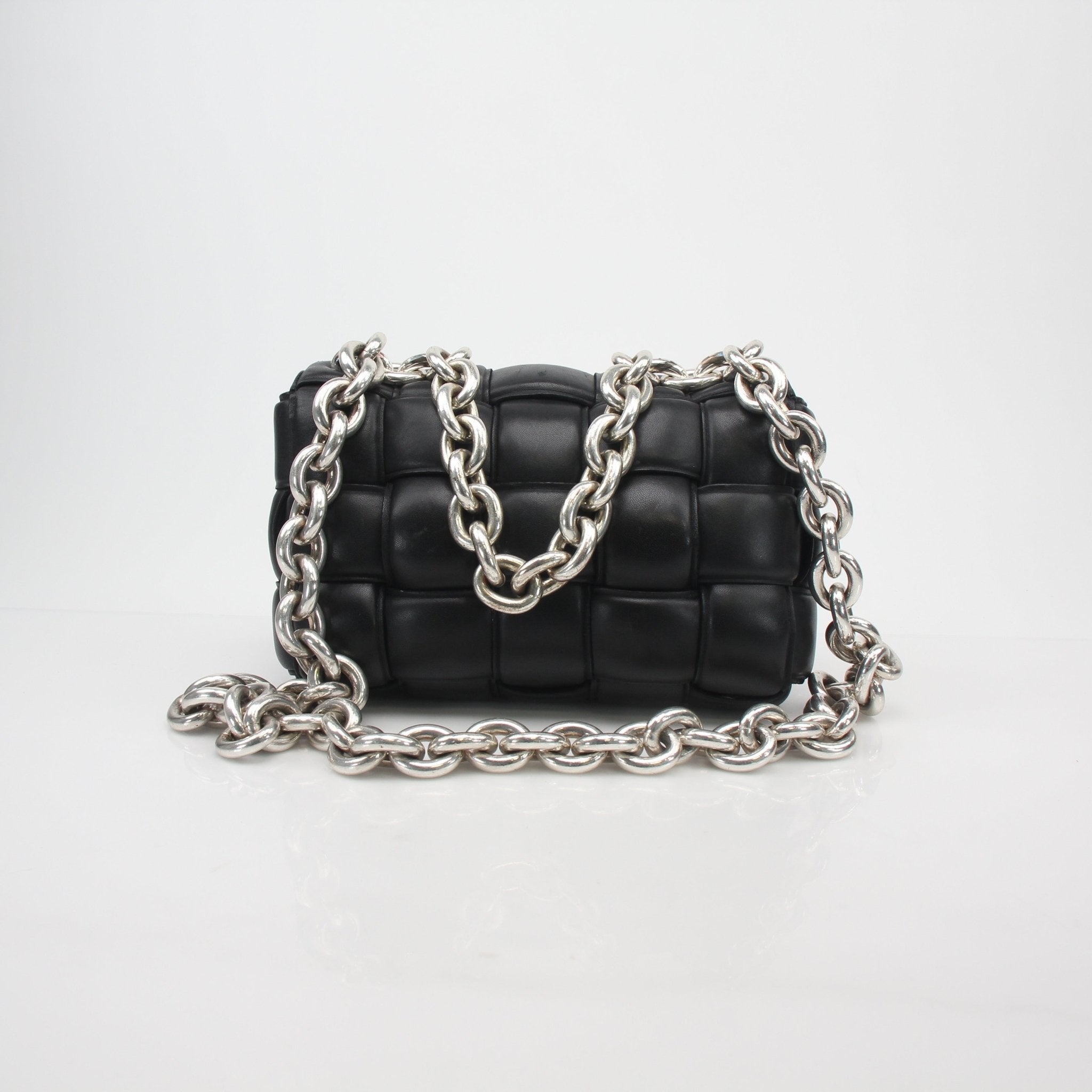 Black Bottega Veneta padded cassette chain shoulder handbag with gold hardware and structured design.