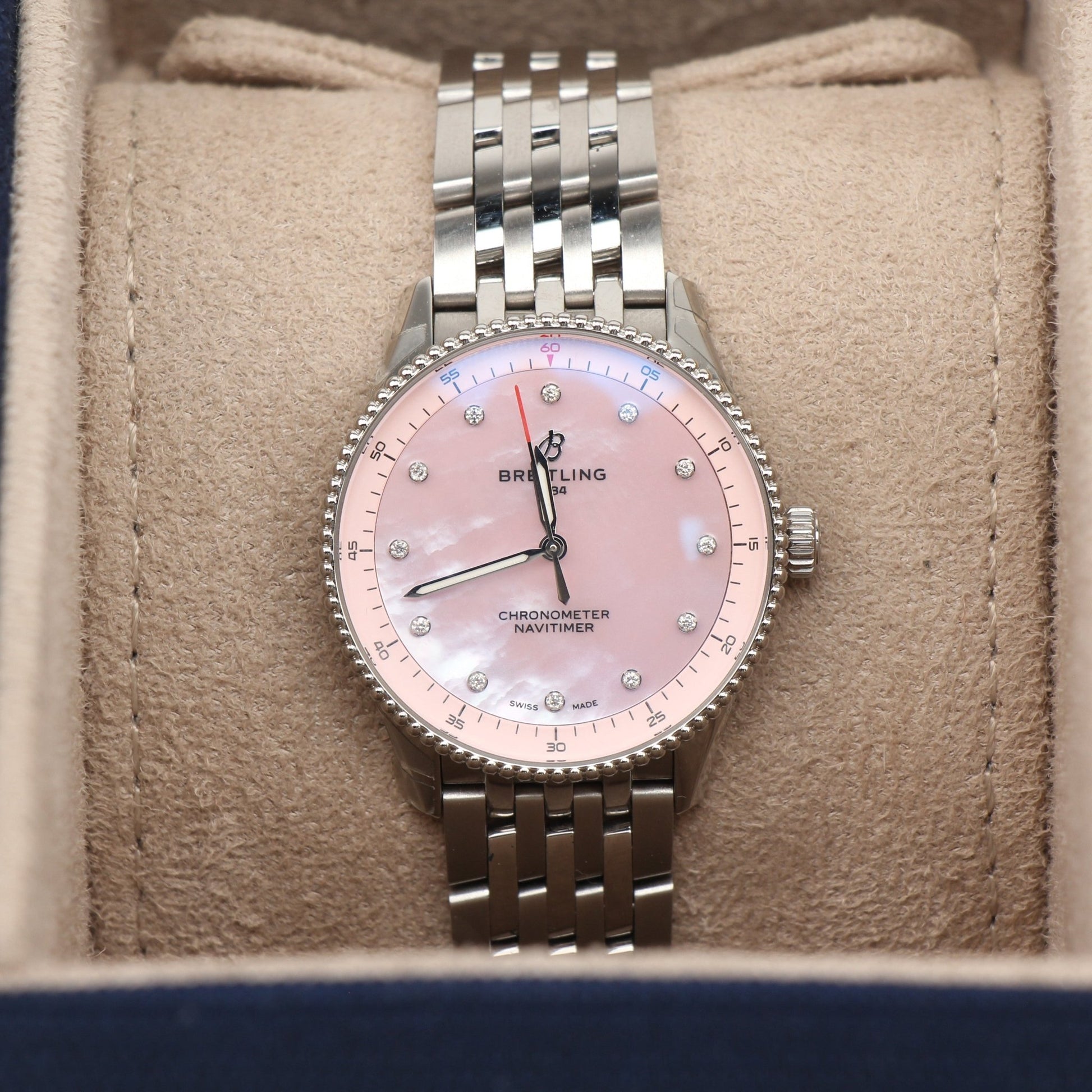 Gold & Beyond Breitling Navitimer 32 watch with silver dial and stainless steel bracelet, showcasing a luxury timepiece.