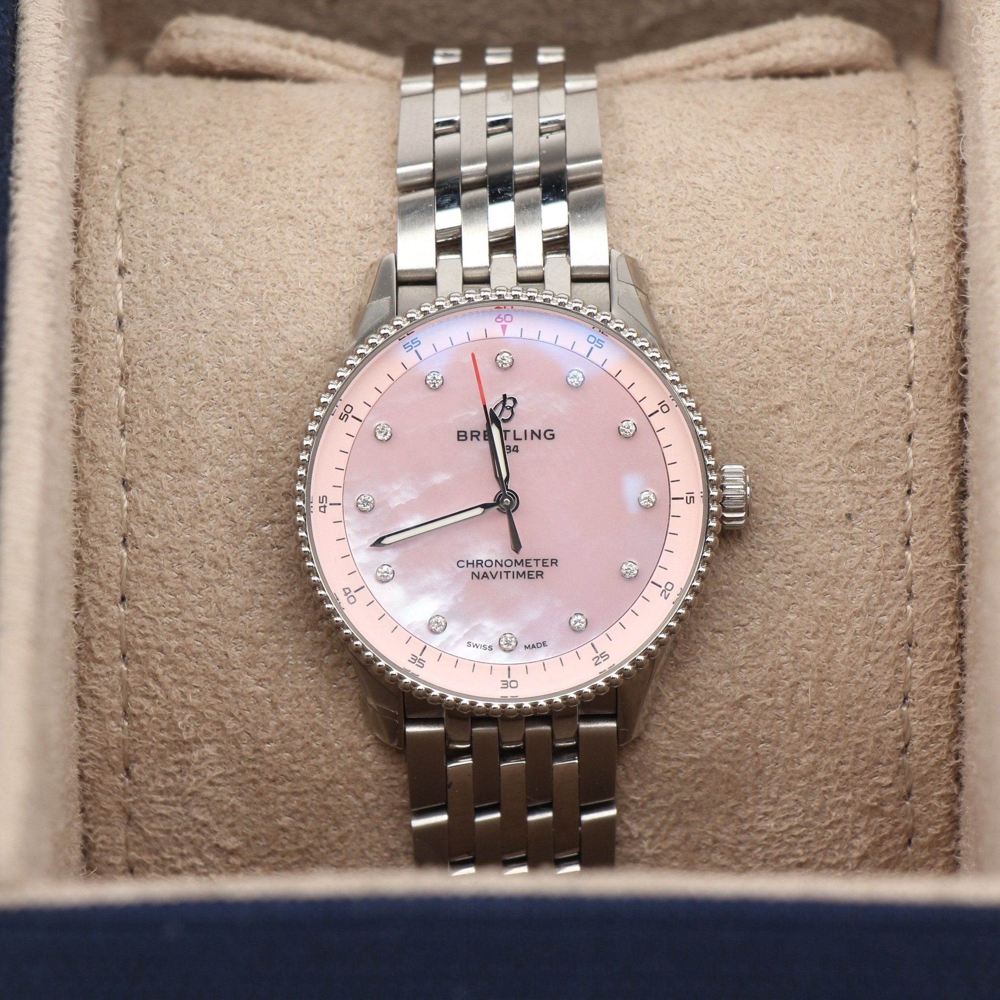 Gold & Beyond Breitling Navitimer 32 watch with silver dial and stainless steel bracelet, showcasing a luxury timepiece.
