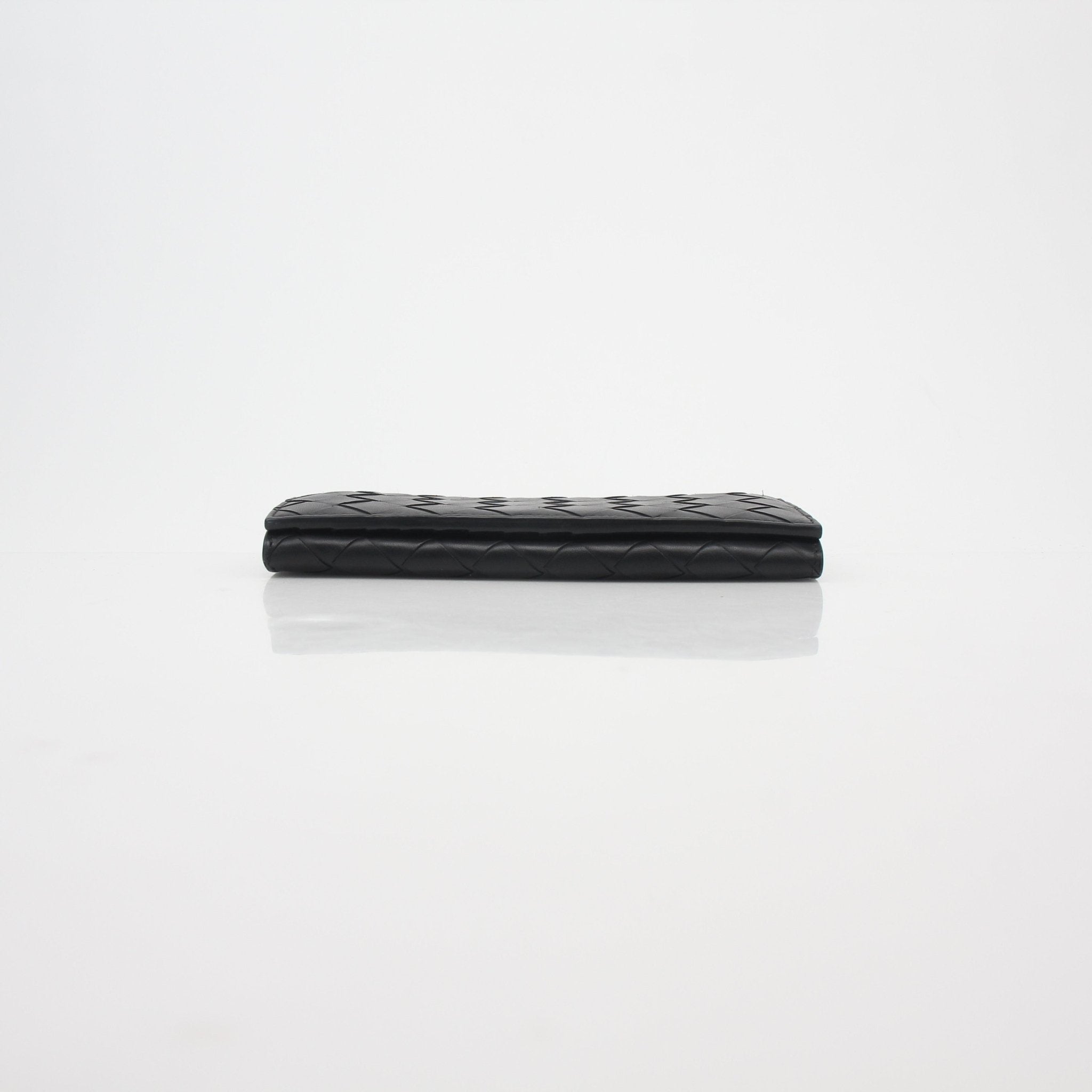 Black Bottega Veneta Intrecciato Continental Wallet with woven leather design, displayed on a white background.