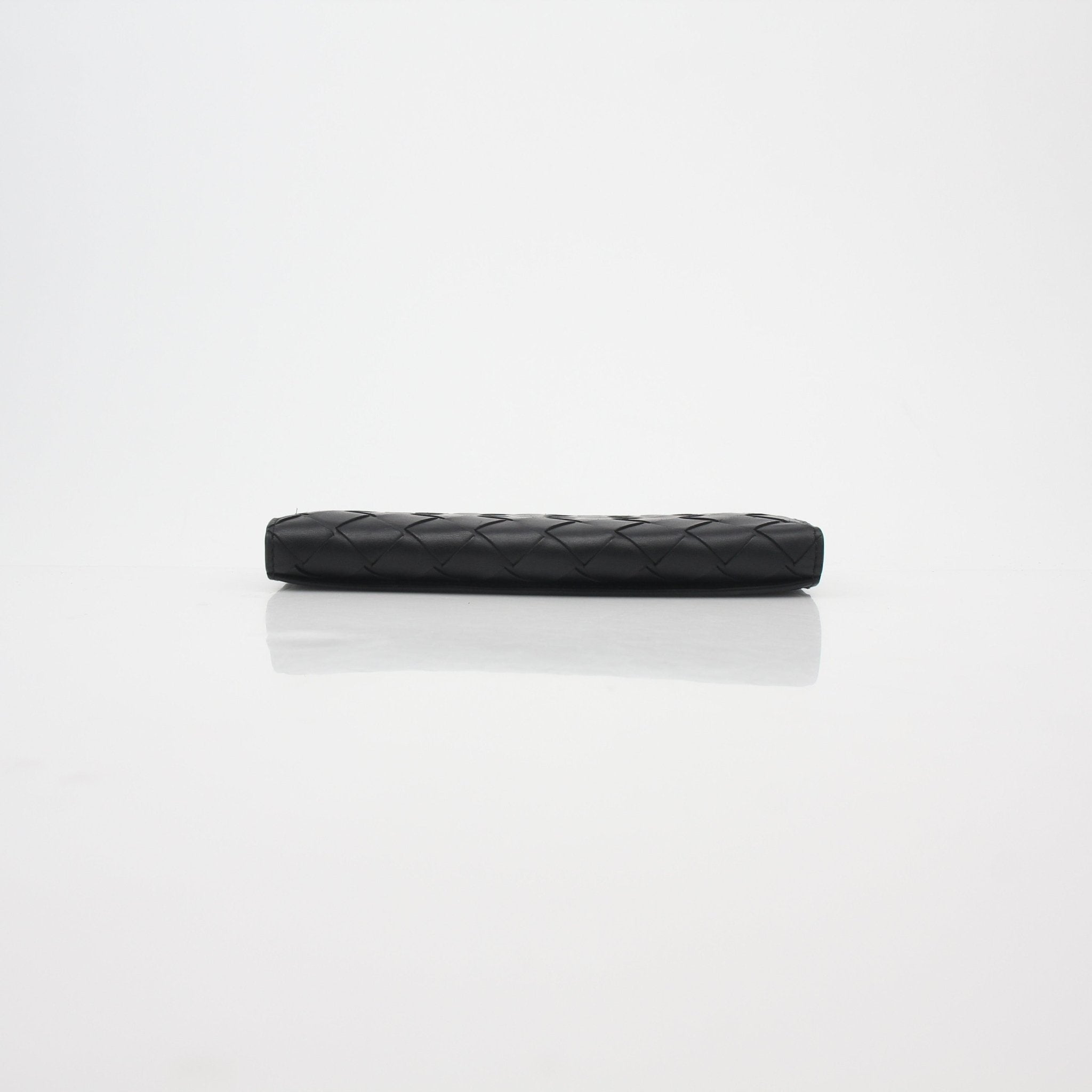 Black Bottega Veneta Intrecciato leather continental wallet with gold accents, shown open with card slots visible.