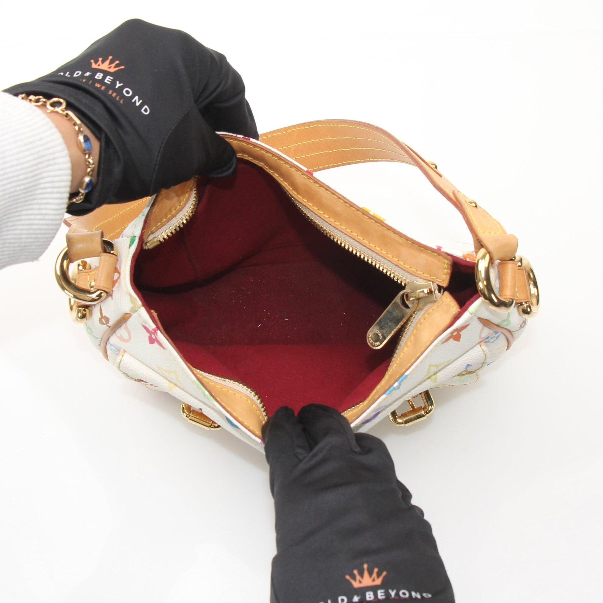Louis Vuitton Lodge PM white shoulder handbag with gold hardware, featuring a structured design and adjustable strap.