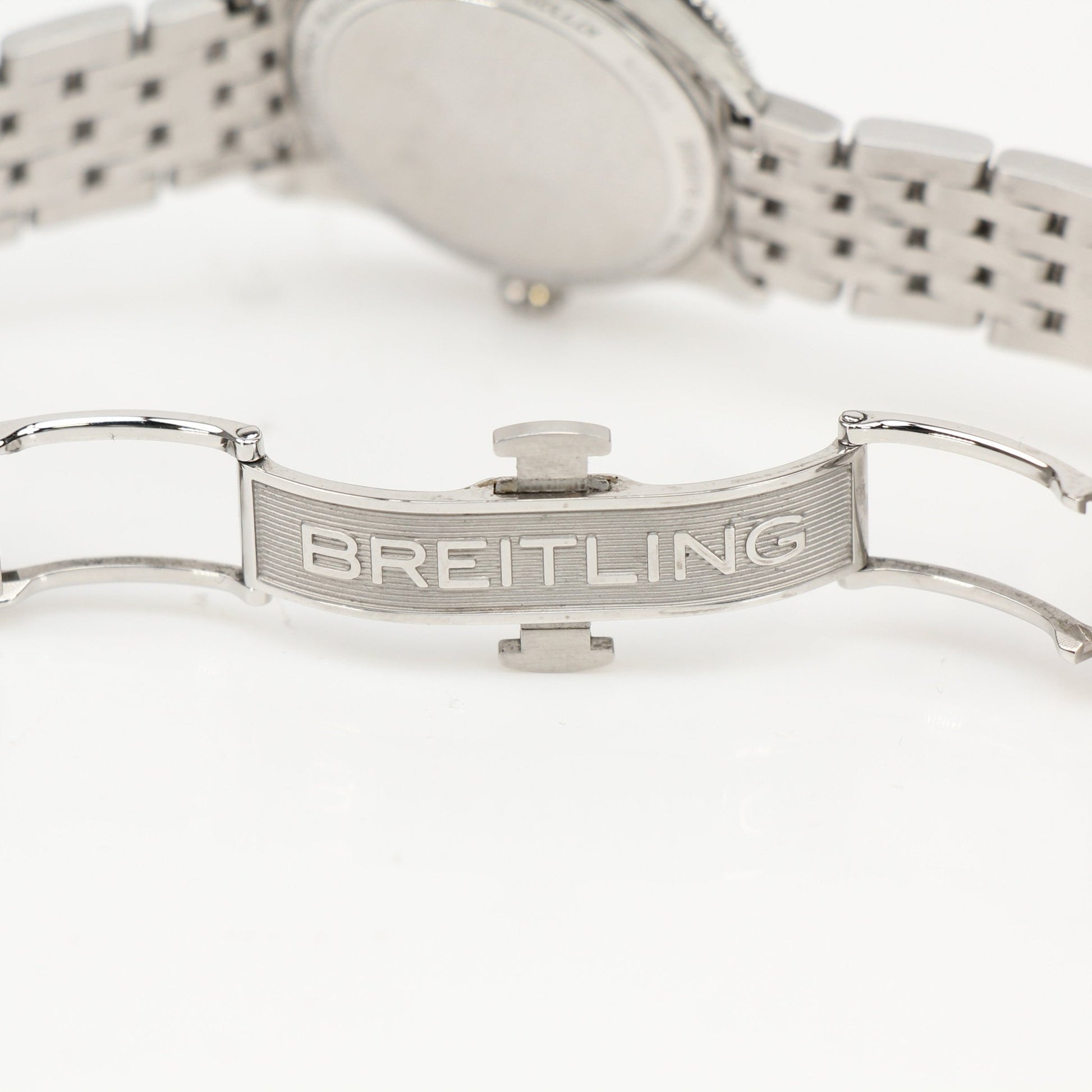 Gold & Beyond Breitling Navitimer 32 watch with stainless steel case, black dial, and gold accents, displayed on a white background.