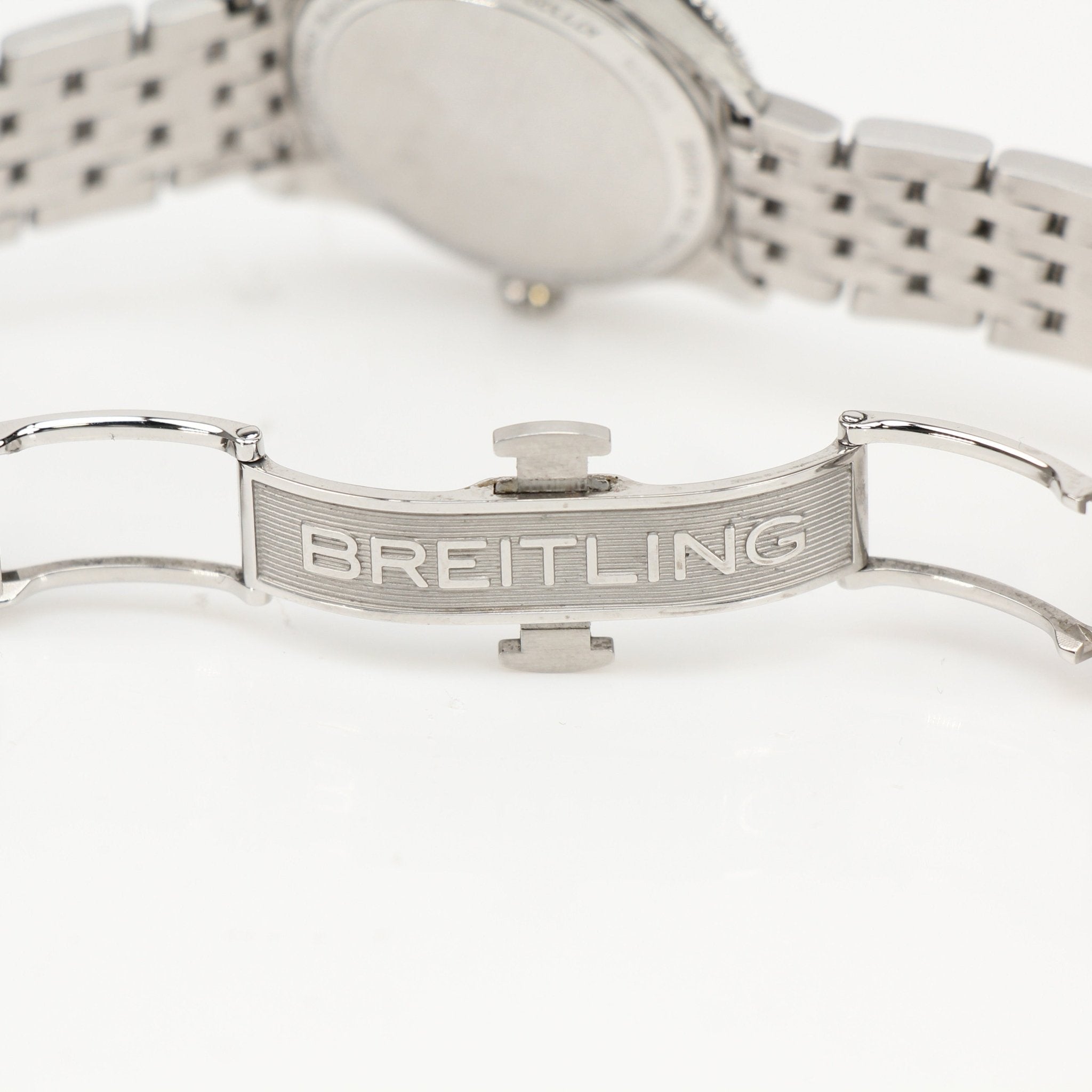 Gold & Beyond Breitling Navitimer 32 watch with stainless steel case, black dial, and gold accents, displayed on a white background.