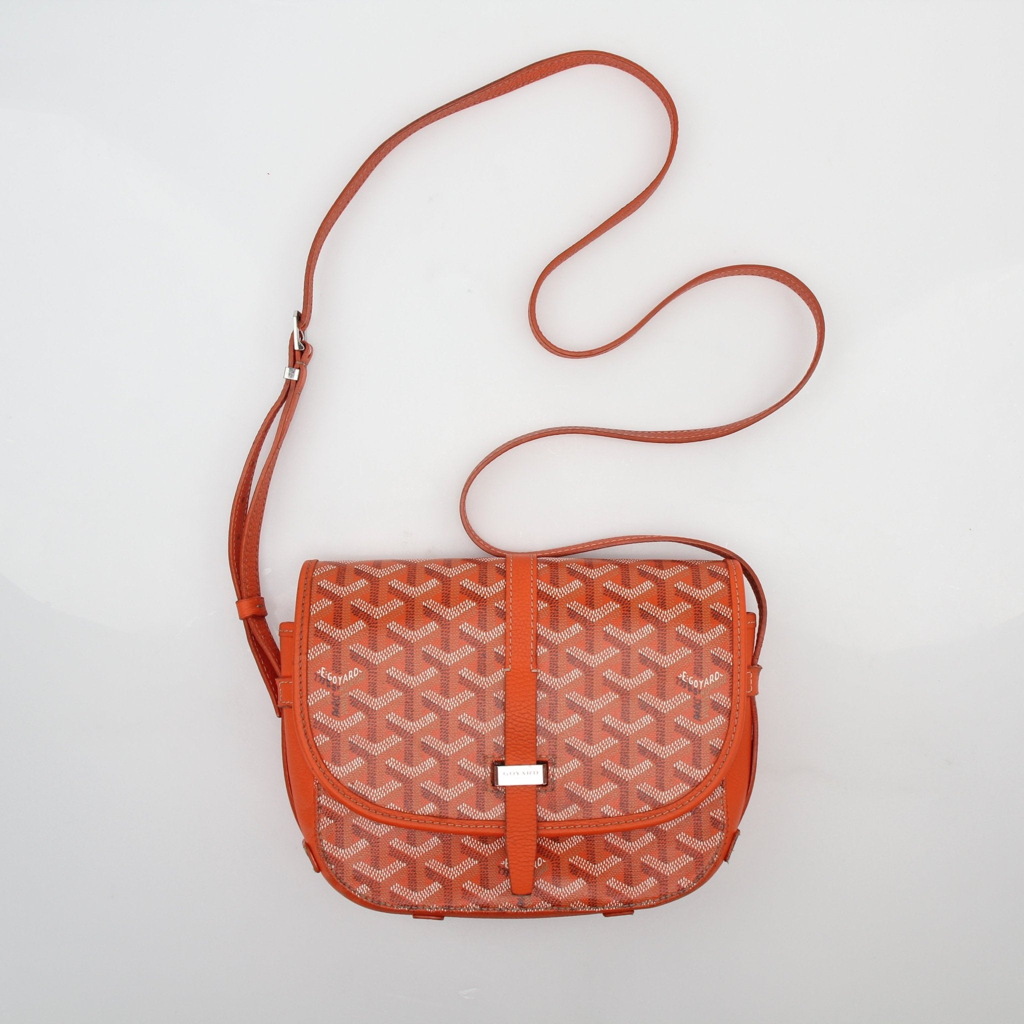 Orange Goyardine Belvédère II PM handbag by Goyard, featuring leather trim and signature pattern, displayed on a neutral background.