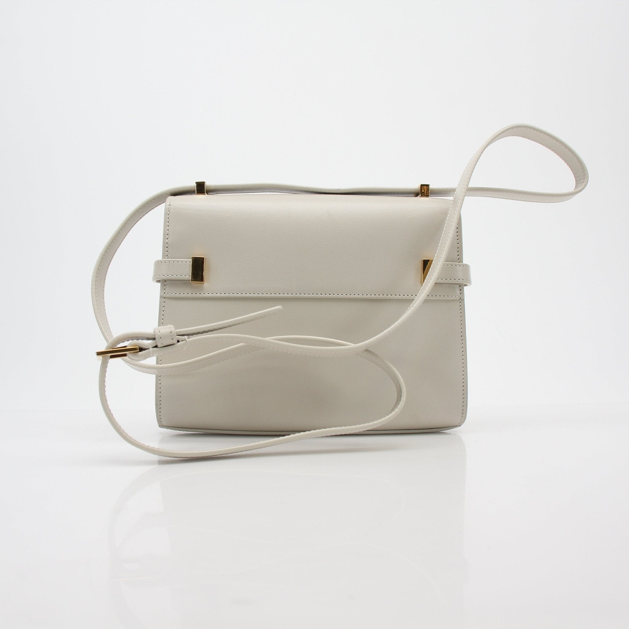 White Saint Laurent Manhattan Shoulder Bag with gold hardware and adjustable strap, stylish handbag for everyday or evening wear.