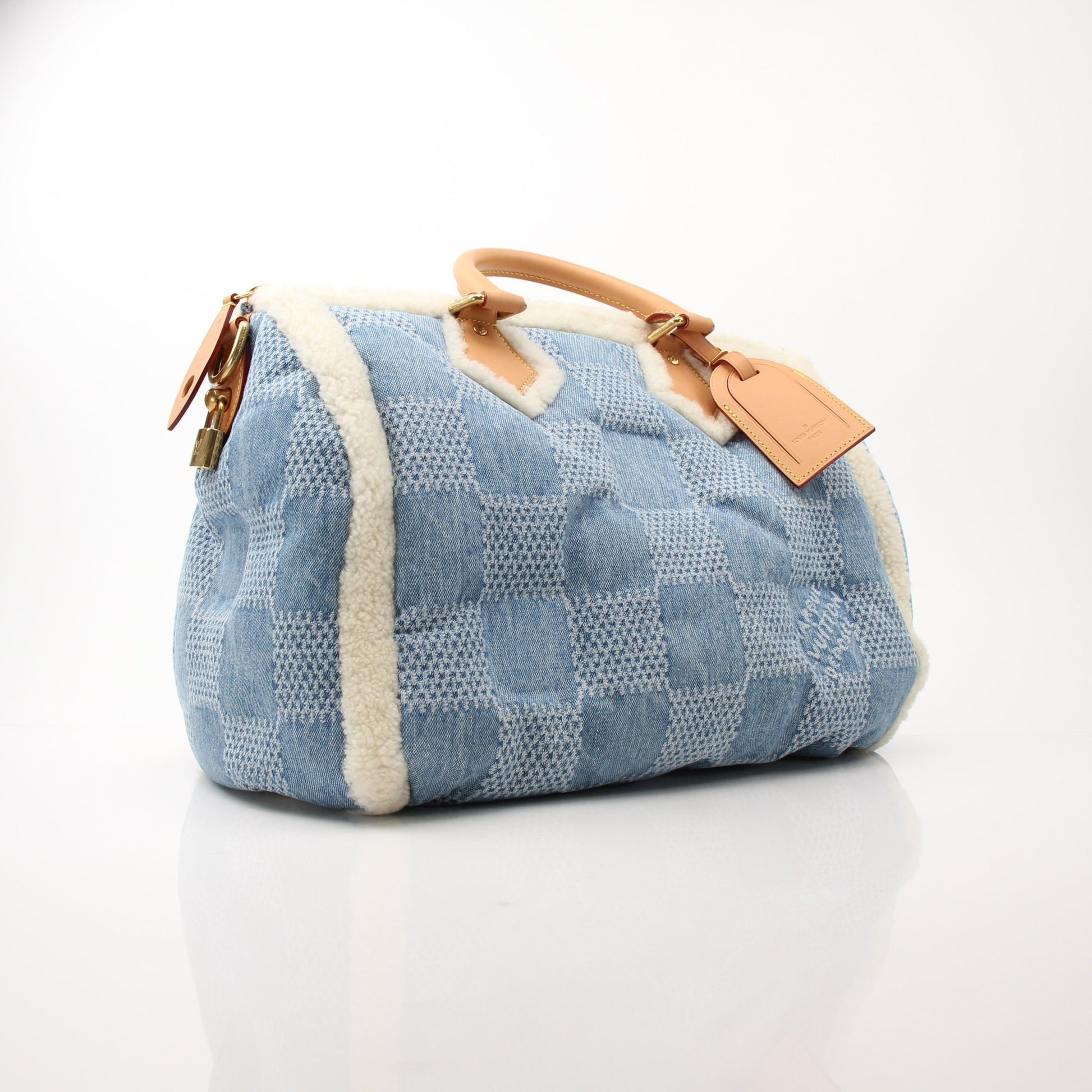 Louis Vuitton Speedy Bandoulière 40 blue winter denim travel bag with leather handles and gold hardware, stylish and spacious.