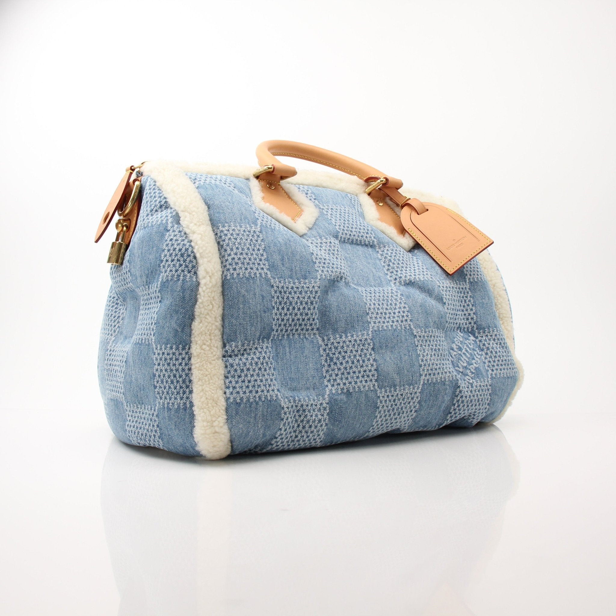 Louis Vuitton Speedy Bandoulière 40 blue winter denim travel bag with leather handles and gold hardware, stylish and spacious.
