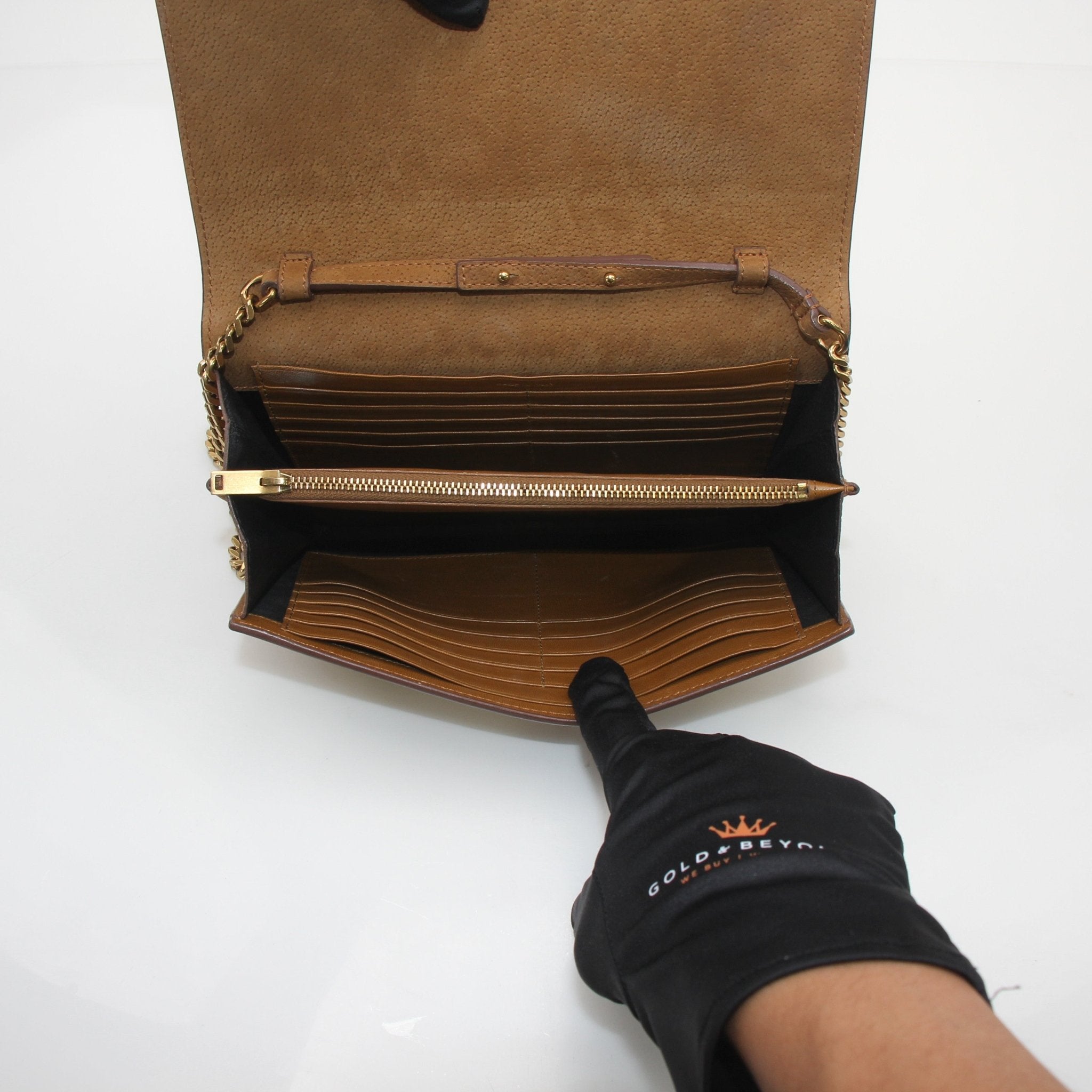 Saint Laurent brown suede Cassandre chain wallet handbag with gold hardware and compact design.