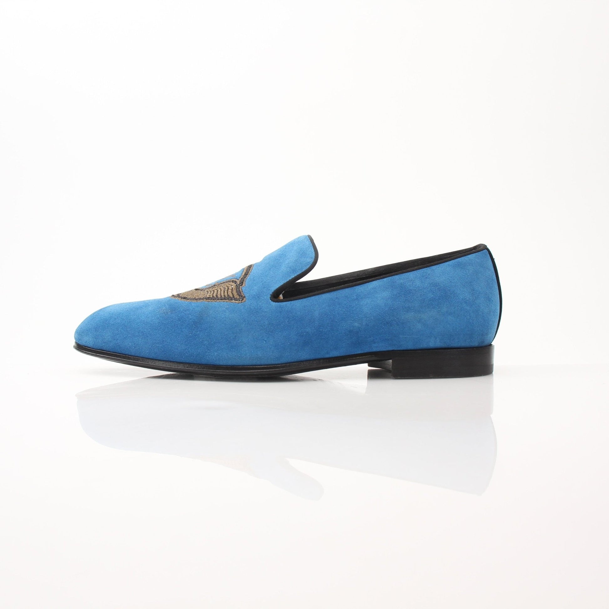 Louis Vuitton blue suede embroidered slip-on loafers with gold accents, showcasing a stylish and comfortable shoe design.