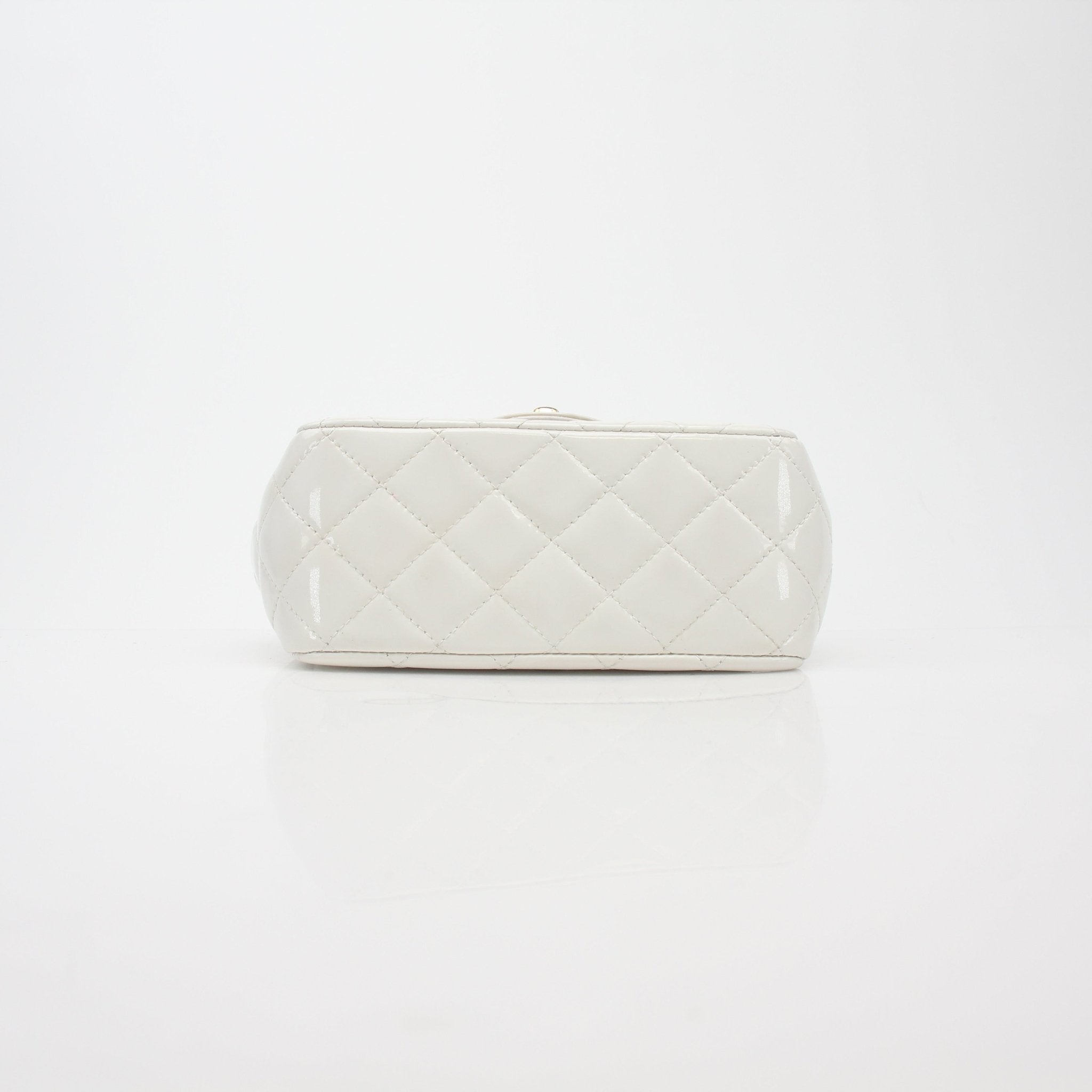 Gold & Beyond Chanel quilted patent leather mini flap handbag with gold chain strap and signature stitching detail.