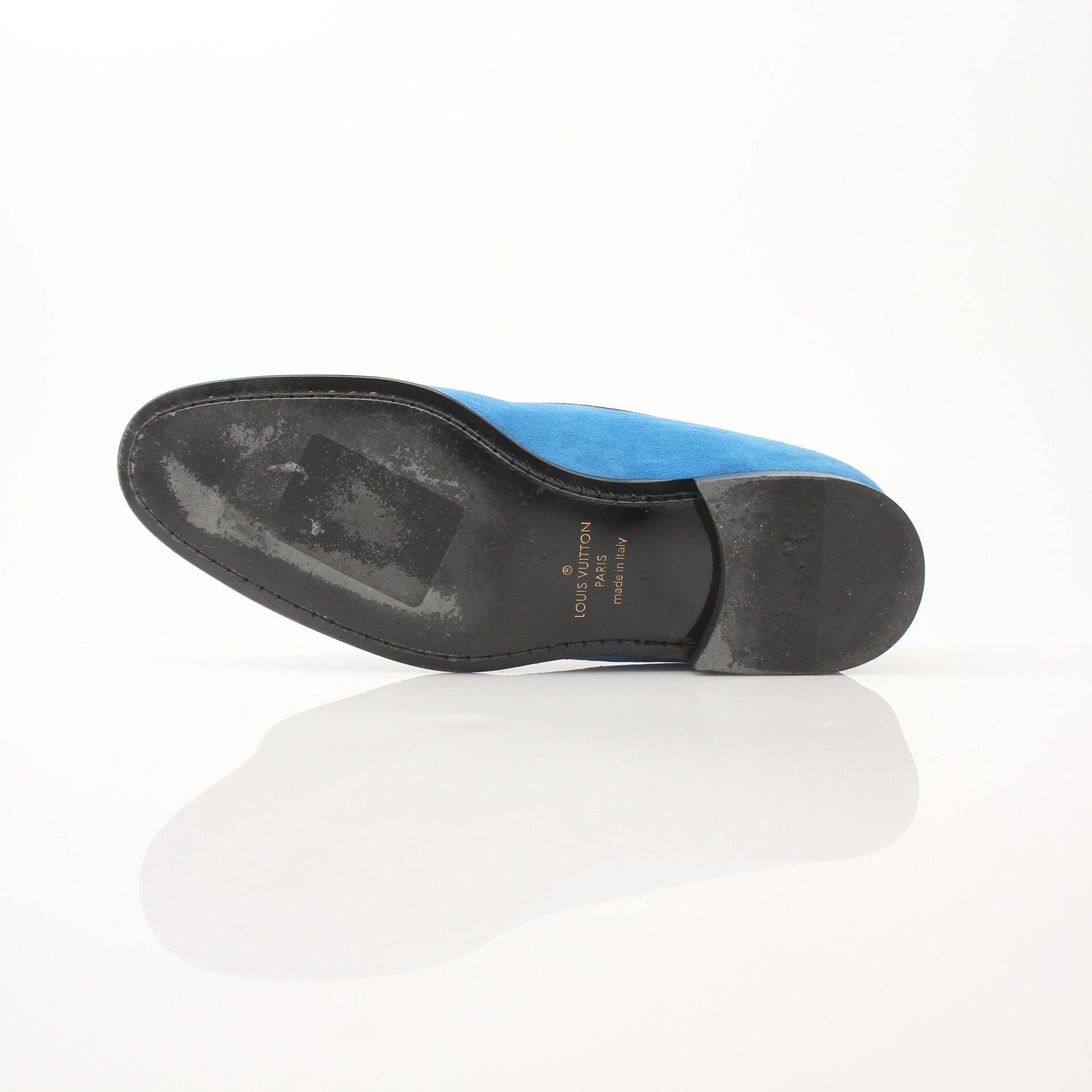 Blue suede Louis Vuitton slip-on loafers with embroidered details, showcased by Gold & Beyond shoes.