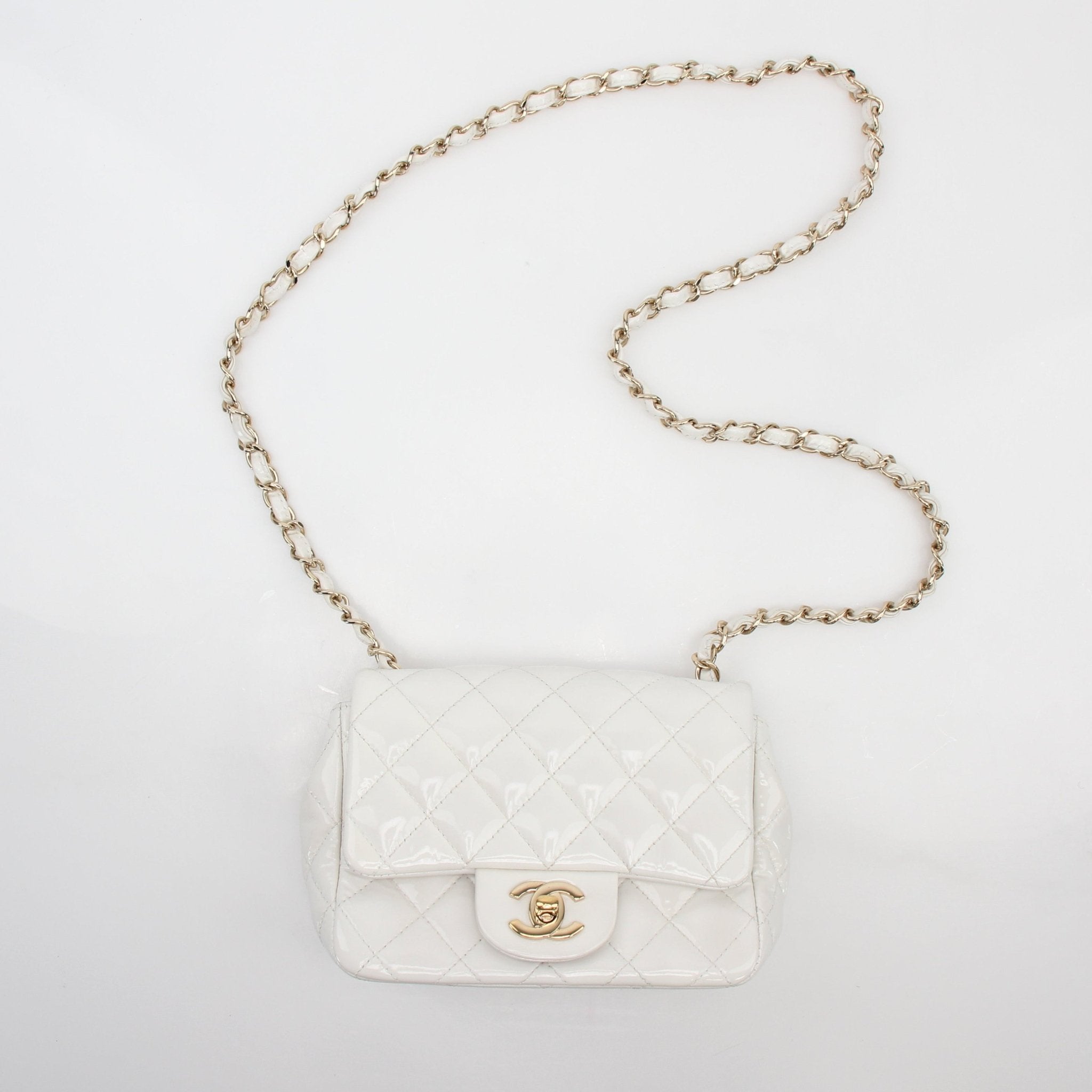 Gold & Beyond Chanel quilted patent leather mini flap handbag with gold chain strap and signature quilting detail.