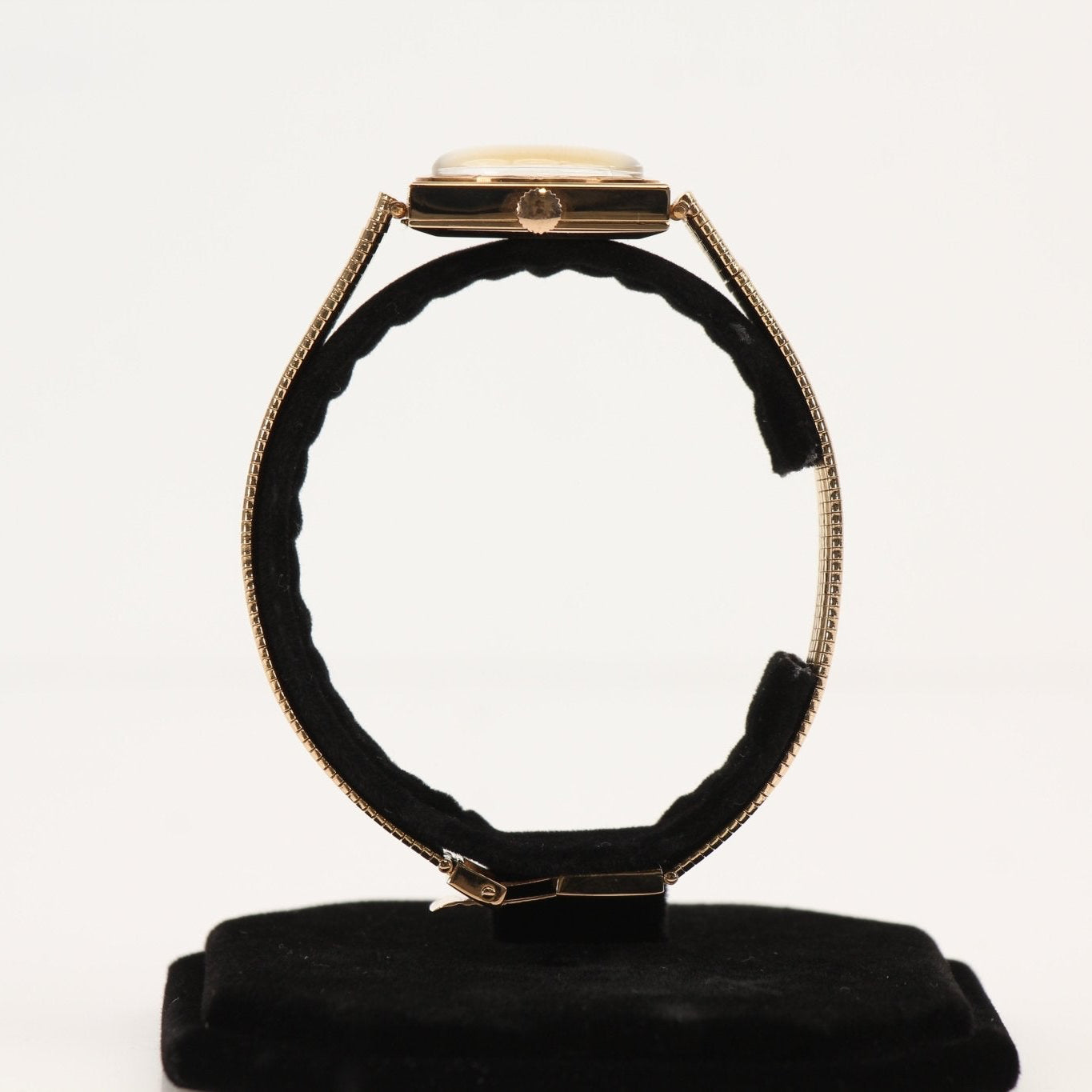 Elegant Jaeger-LeCoultre gold dress watch with a sleek design and classic round face, displayed on a neutral background.