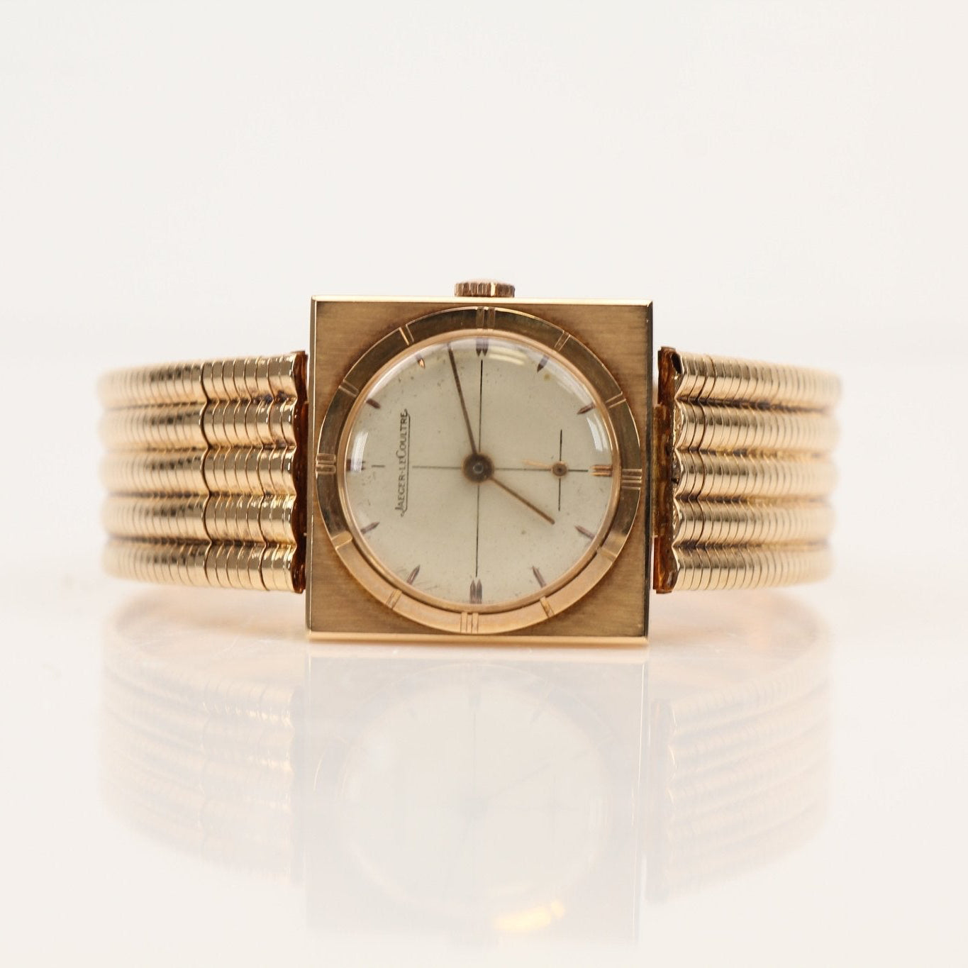 Elegant Jaeger-LeCoultre gold dress watch with a sleek round face and gold band, showcased on a neutral background.