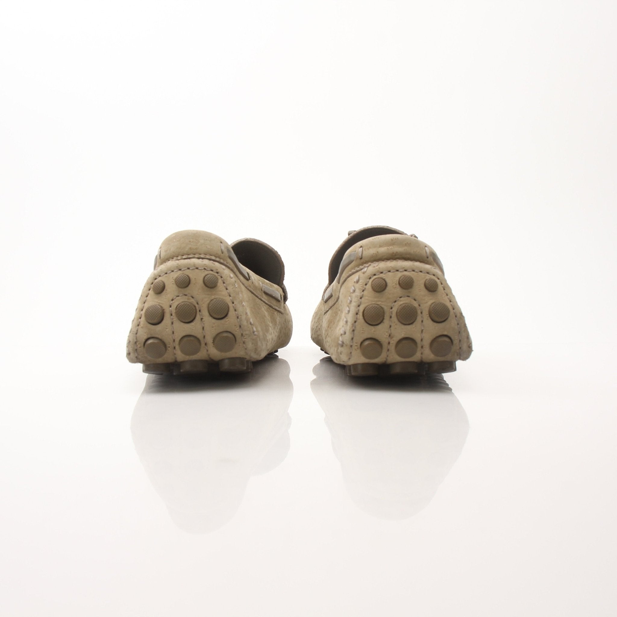 Louis Vuitton LV Driver Moccasins in beige suede, stylish loafers with classic design, worn on feet.