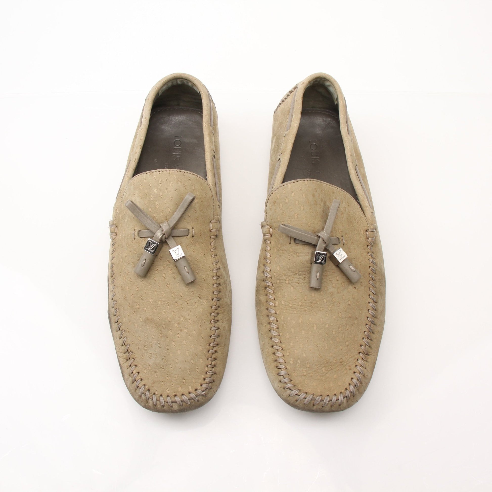 Louis Vuitton LV Driver Moccasins in beige suede, stylish loafers with classic design, featuring gold accents on the shoes.