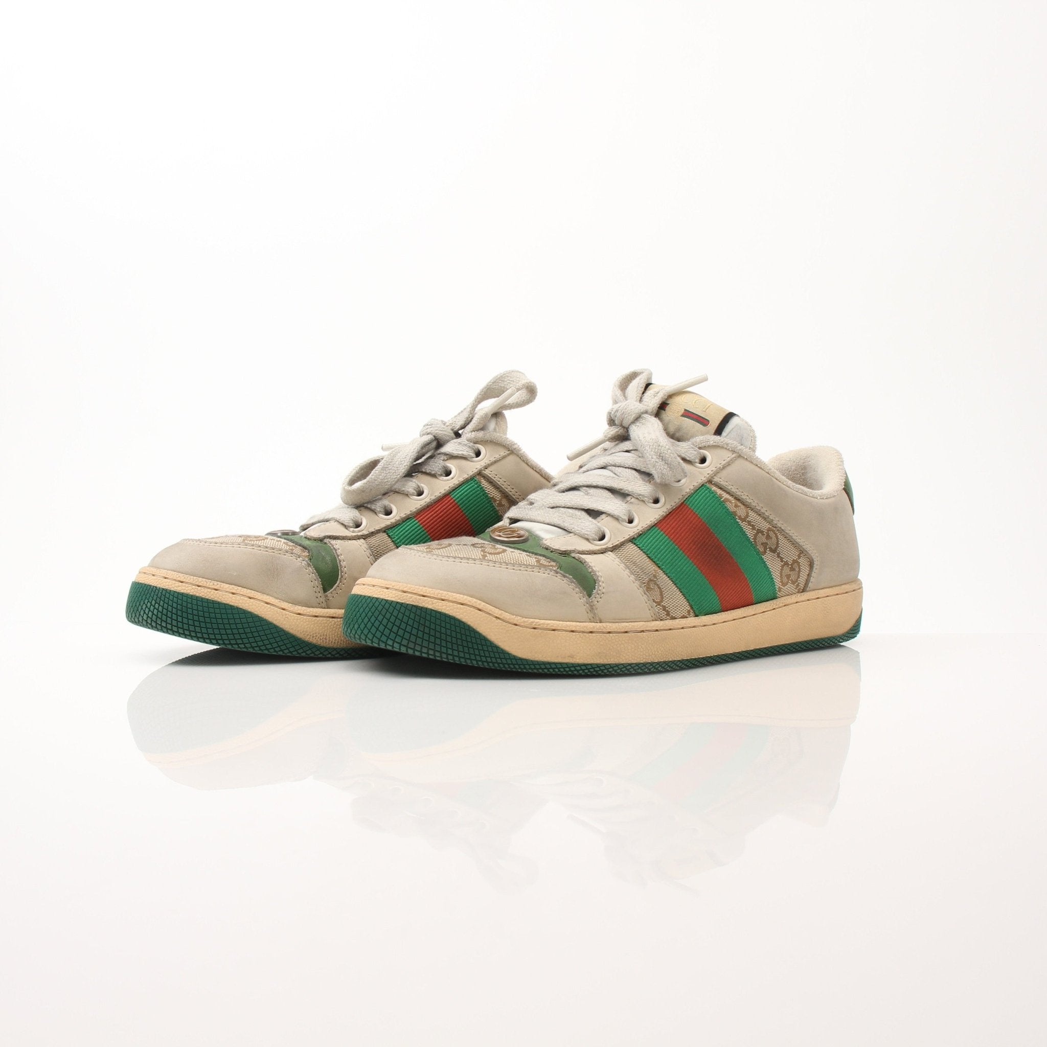 Gold & Beyond Gucci men's distressed effect screener sneakers, close-up showing textured leather and casual sneaker design.
