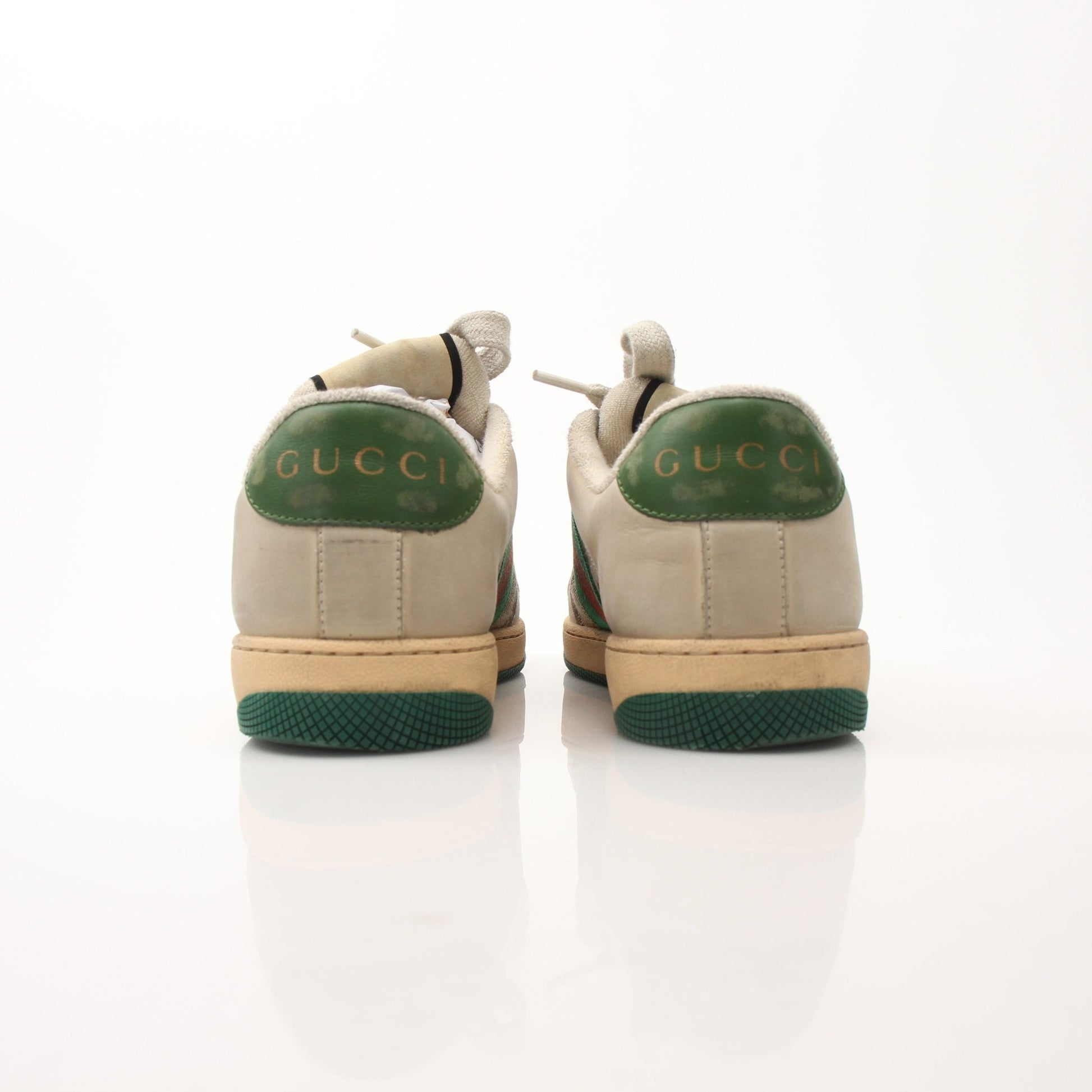 Gucci men's distressed effect Screener sneakers with black and white design, casual shoes with textured finish and logo details.