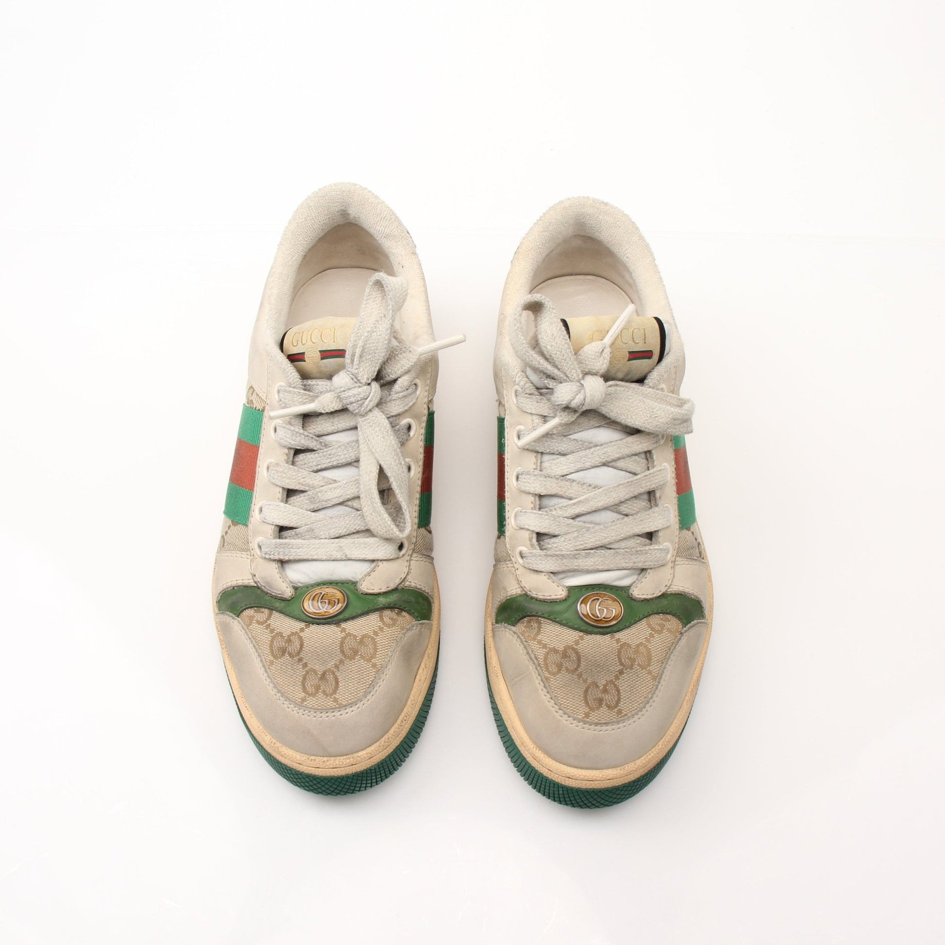 Gold & Beyond Gucci men's distressed effect screener sneakers, showing worn-in leather shoes with stylish design details.