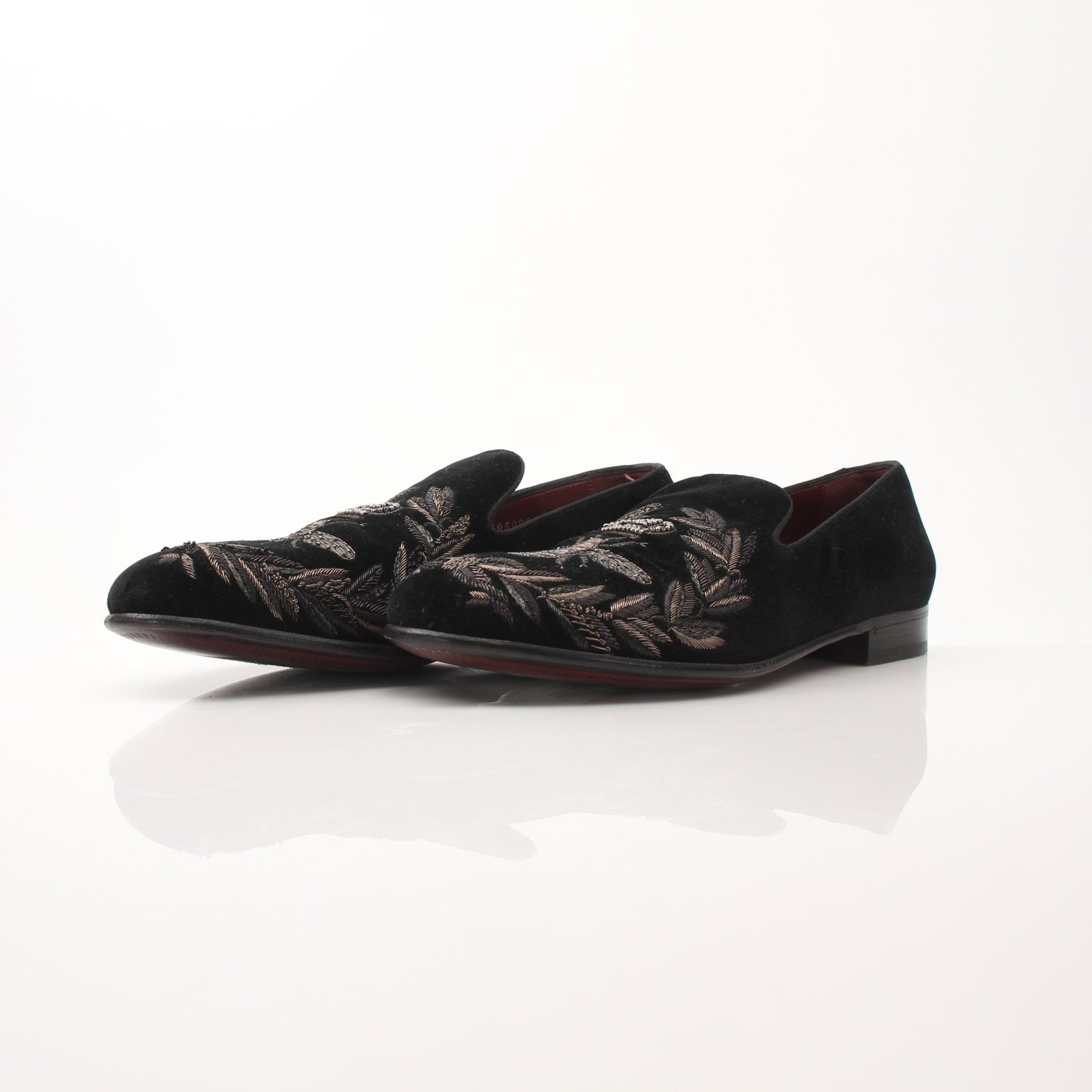 Black velvet loafers with gold bee and crown embroidery by Dolce & Gabbana, stylish shoes with intricate details.
