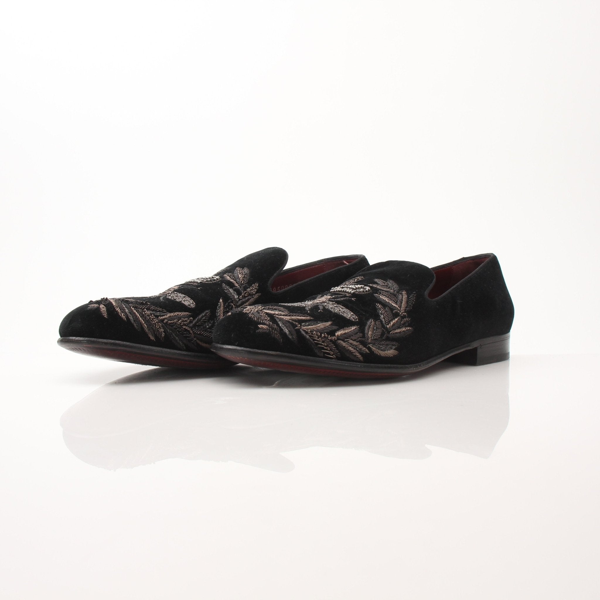 Black velvet loafers with gold bee and crown embroidery by Dolce & Gabbana, stylish shoes with intricate details.