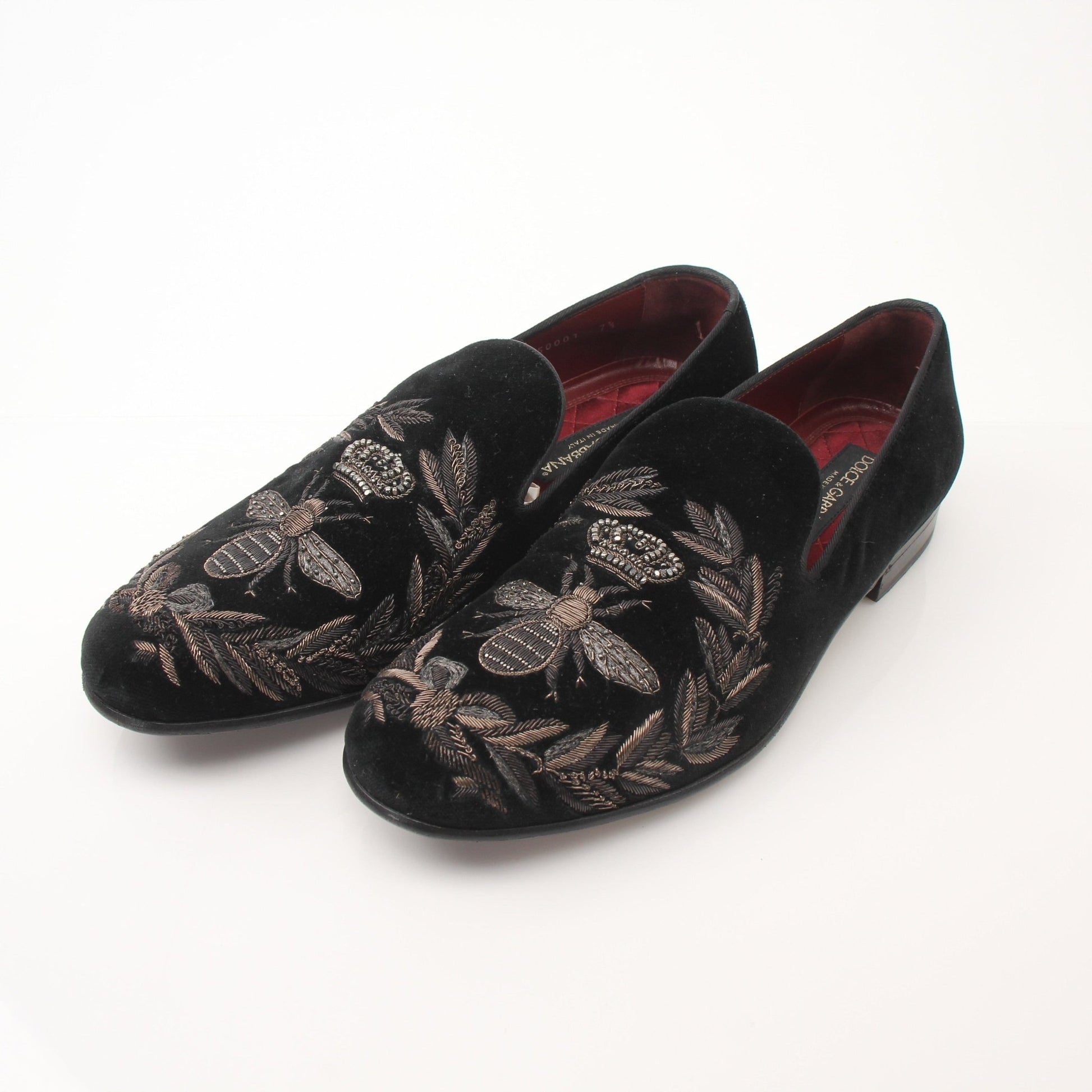 Black velvet loafers with gold bee and crown embroidery from Dolce & Gabbana, featuring elegant details and a classic slip-on design.