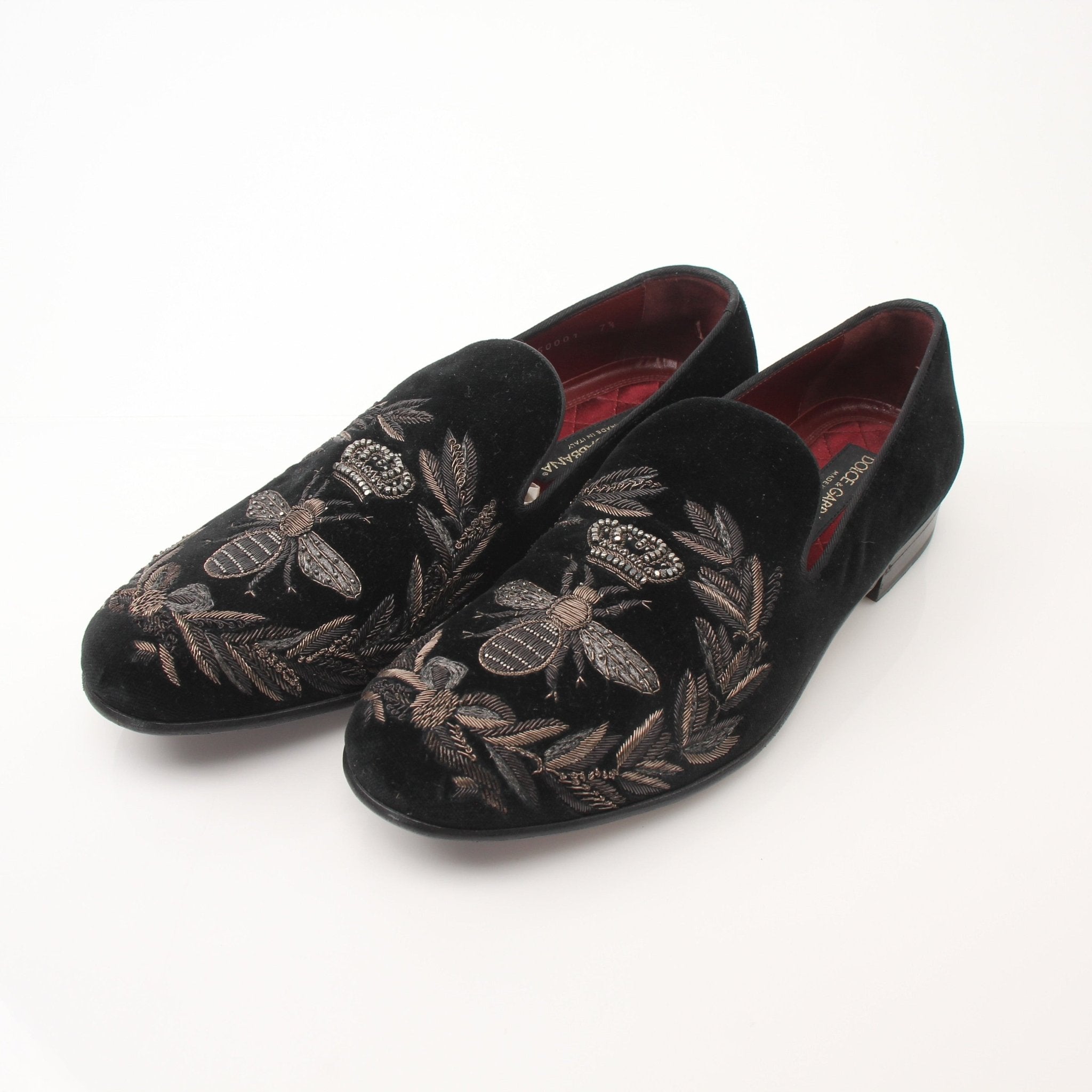 Black velvet loafers with gold bee and crown embroidery from Dolce & Gabbana, featuring elegant details and a classic slip-on design.