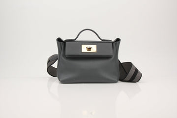 Hermès 24/24 handbag featuring elegant gold hardware and a sleek design, showcased in a stylish setting.