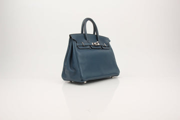 Hermès Birkin 35 in blue leather featuring palladium hardware, showcasing a classic and elegant handbag design.