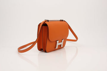 Hermès Constance handbag in orange Epsom leather featuring palladium hardware, showcasing elegant design and craftsmanship.