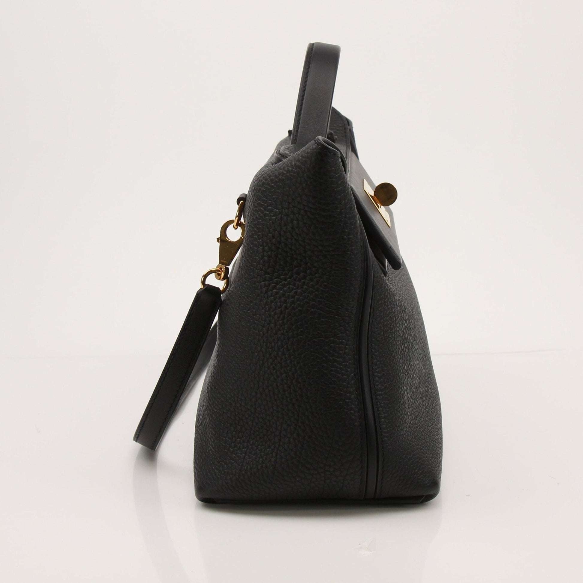 Hermès Top Handle Clemence handbag in beige leather with gold hardware, featuring a structured design and top handle.
