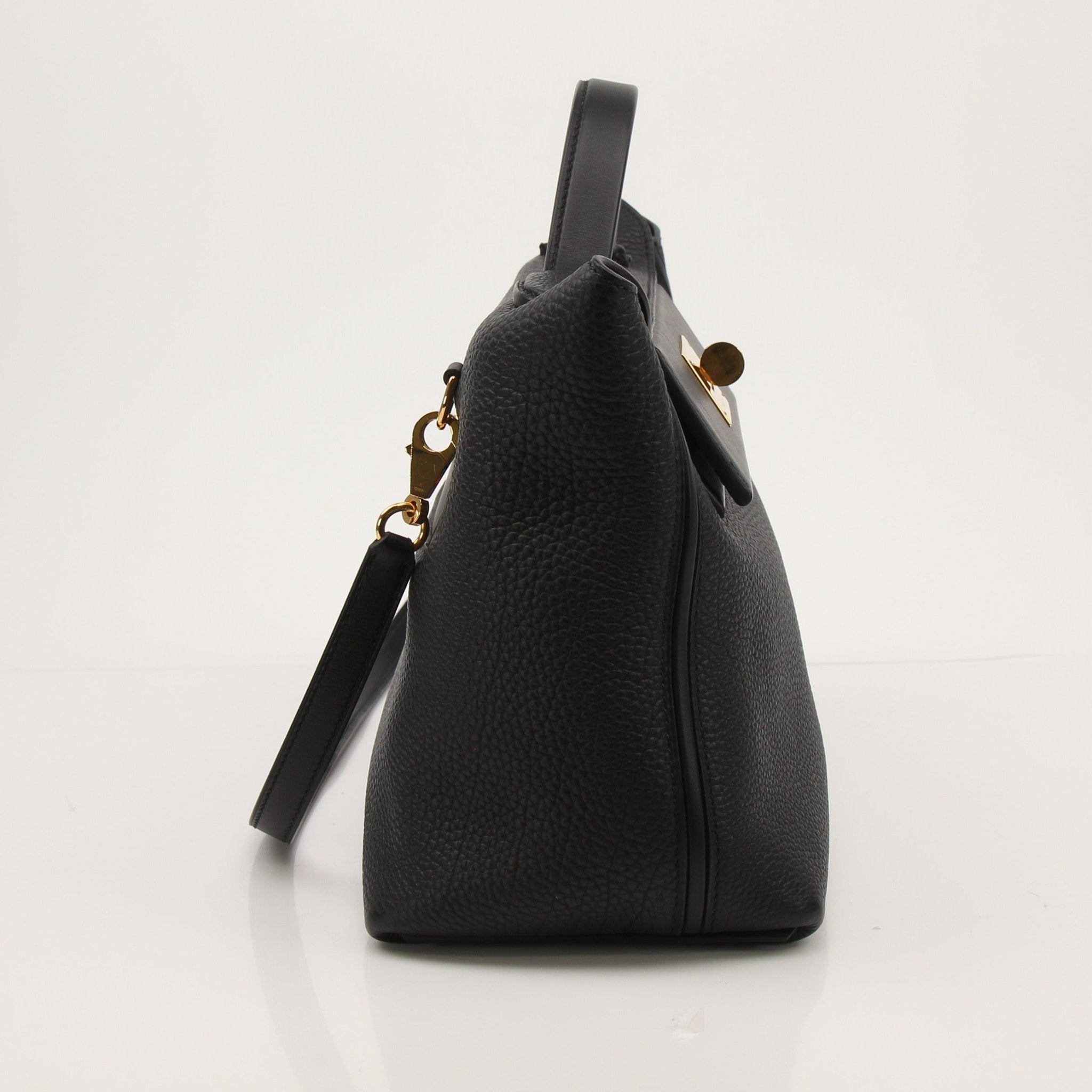 Hermès Top Handle Clemence handbag in beige leather with gold hardware, featuring a structured design and top handle.