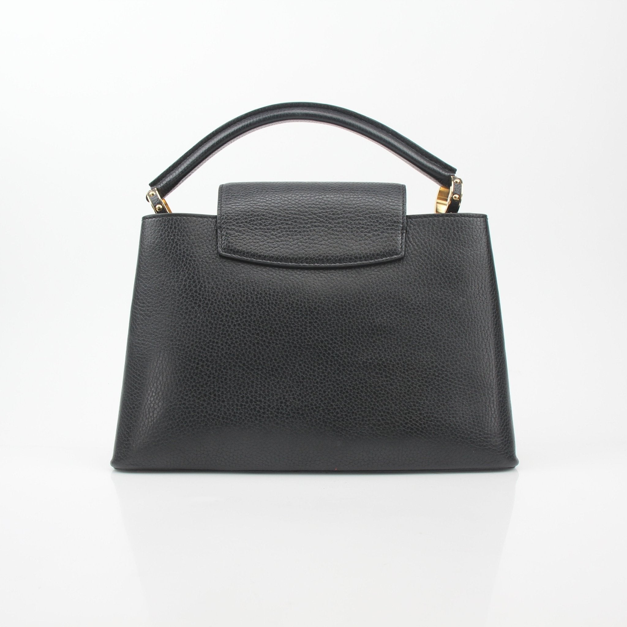Louis Vuitton Capucines PM handbag with black leather and mechanical flower embellishments, shown with gold hardware and elegant design.