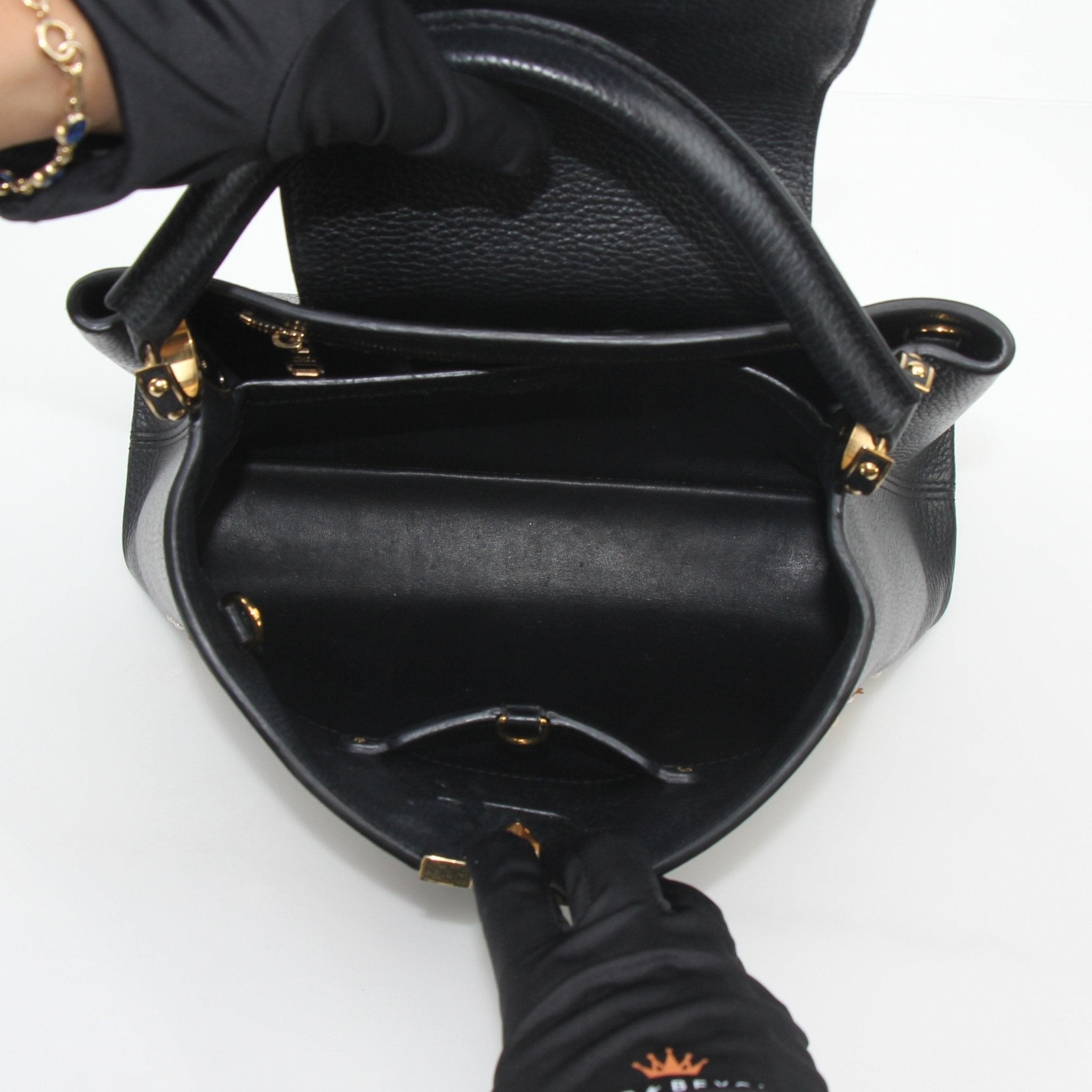 Louis Vuitton Capucines PM handbag with mechanical flowers design, black leather, gold hardware, and structured shape.