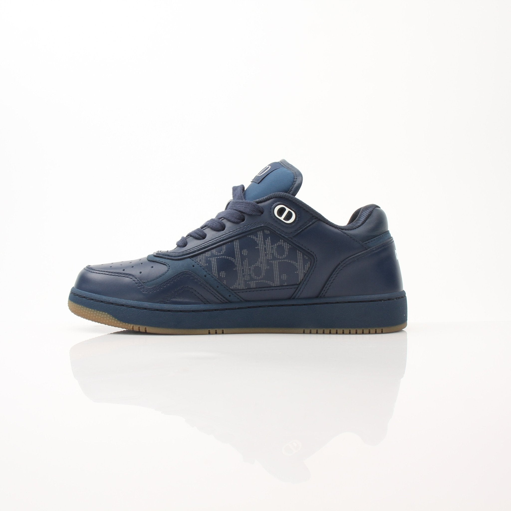 Christian Dior Navy Oblique sneakers featuring classic design and Dior branding, shown with white soles on a plain background.
